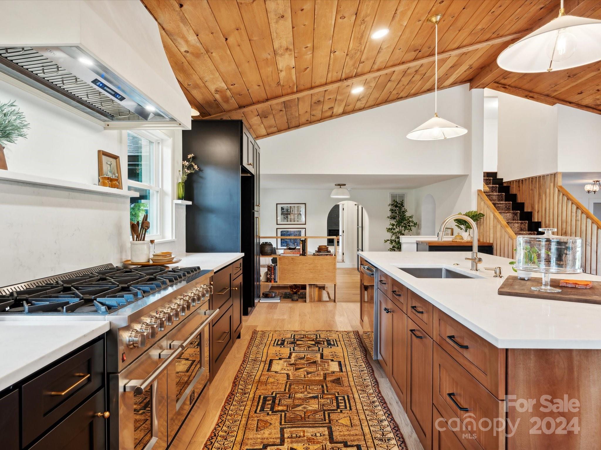 Prepare for an experience like you have never seen, the custom finishes and attention to detail fill every room!  Across the threshold begin a breathtaking tour of this one of a kind MCM! Vaulted wood ceilings accent the gourmet kitchen, dining and sitting areas while sunlight spills through the large picturesque window that overlooks the meticulously manicured yard! Prepare all your favorite meals in the kitchen crafted for a culinary artist! Get cozy in the media room with your favorite movie or retreat to the primary suite where rest and relaxation await! The primary bath has an expansive walk in shower, double sinks and custom built ins! Also on the main floor is a laundry room and a flex/office/ dining space.  Upstairs are three more generous sized rooms and another bath finished off with "not your average" tile! Sneak through the door under the stairs and you will find your own speakeasy!  Outside enjoy all four of our sweet southern seasons from the covered porch and deck!