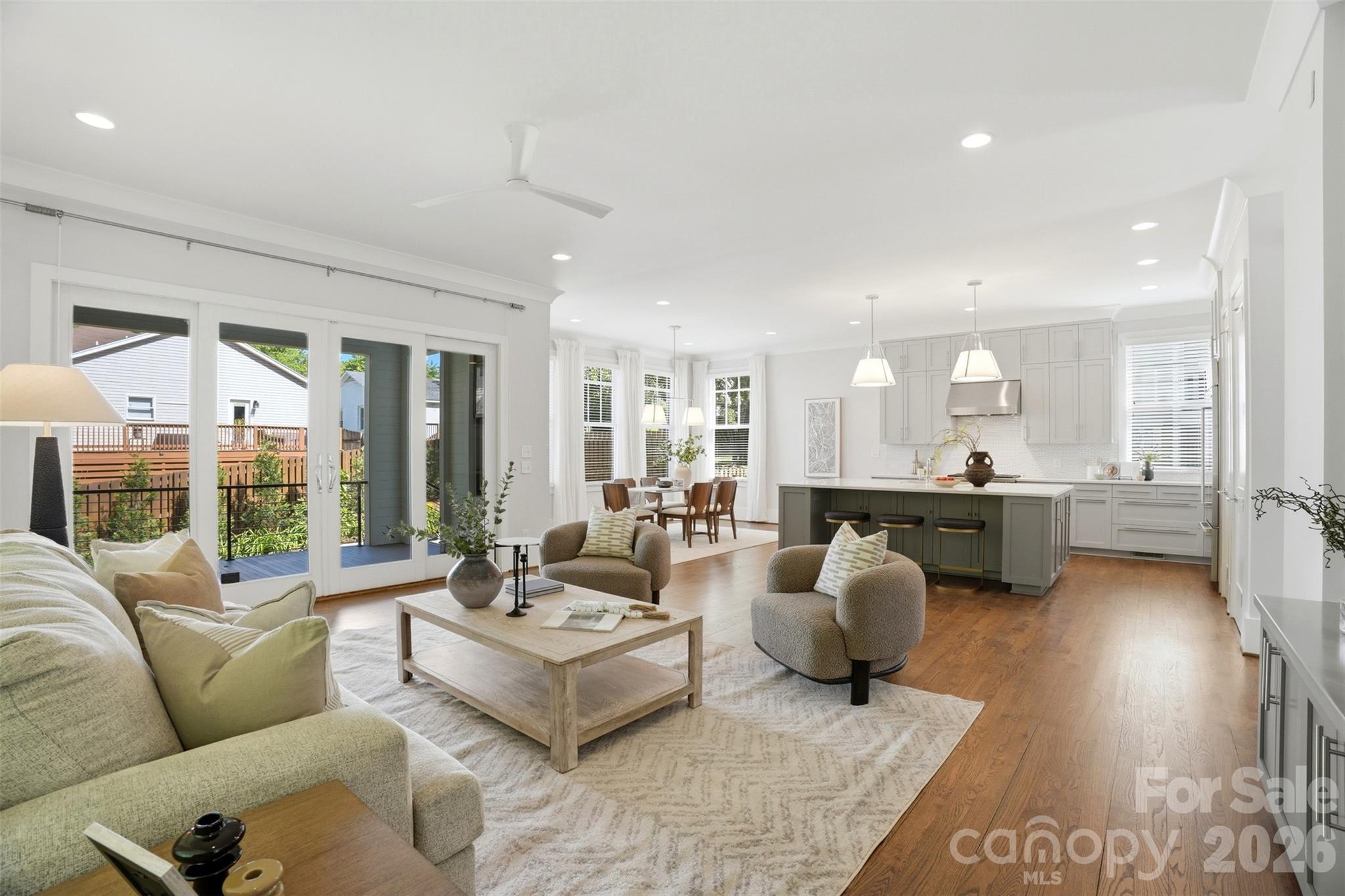 Modern sophistication meets natural serenity in this exceptional residence, perfectly positioned at the end of a quiet street in the highly sought-after historic Cherry neighborhood. Framed by a tranquil creek and a lush, wooded backdrop, the setting delivers rare privacy while remaining just moments from the vibrancy of Uptown Charlotte.

Inside, rich hardwood floors and an abundance of natural light define the open-concept main level, where soaring 10-foot ceilings elevate the sense of scale and sophistication. The living, dining and kitchen areas flow seamlessly together, creating an ideal layout for both refined entertaining and effortless everyday living.

At the center of the home, a true chef’s kitchen impresses with a Wolf gas range, Sub-Zero refrigerator, expansive island with custom wine storage and extensive cabinetry designed for both beauty and function. Sliding glass doors extend the living space outdoors to a covered patio and professionally landscaped, fully fenced-in backyard oasis, complete with mature plantings and a paver terrace, offering you a seamless indoor-outdoor lifestyle.

A main-level bedroom and full bath provide valuable flexibility for guests or a private office suite.

Upstairs, 9-foot ceilings continue the elevated design across three additional bedrooms, including a serene primary suite that serves as a true retreat. The spa-inspired bath features an oversized walk-in shower, dual sink vanity and two spacious walk-in closets with custom built-ins. Two additional upstairs bedrooms are generously sized, filled with natural light, and share a well-appointed full bath.

The lower level expands the home’s versatility with a private bedroom and half bath, separate entrance and covered patio, offering you the ideal setup for guests, multi-generational living or a dedicated and private work-from-home suite.

A spacious three-car garage with built-in cabinetry and additional storage completes this thoughtfully designed home, where modern luxury, privacy and natural beauty converge in one of Charlotte’s most coveted neighborhoods!