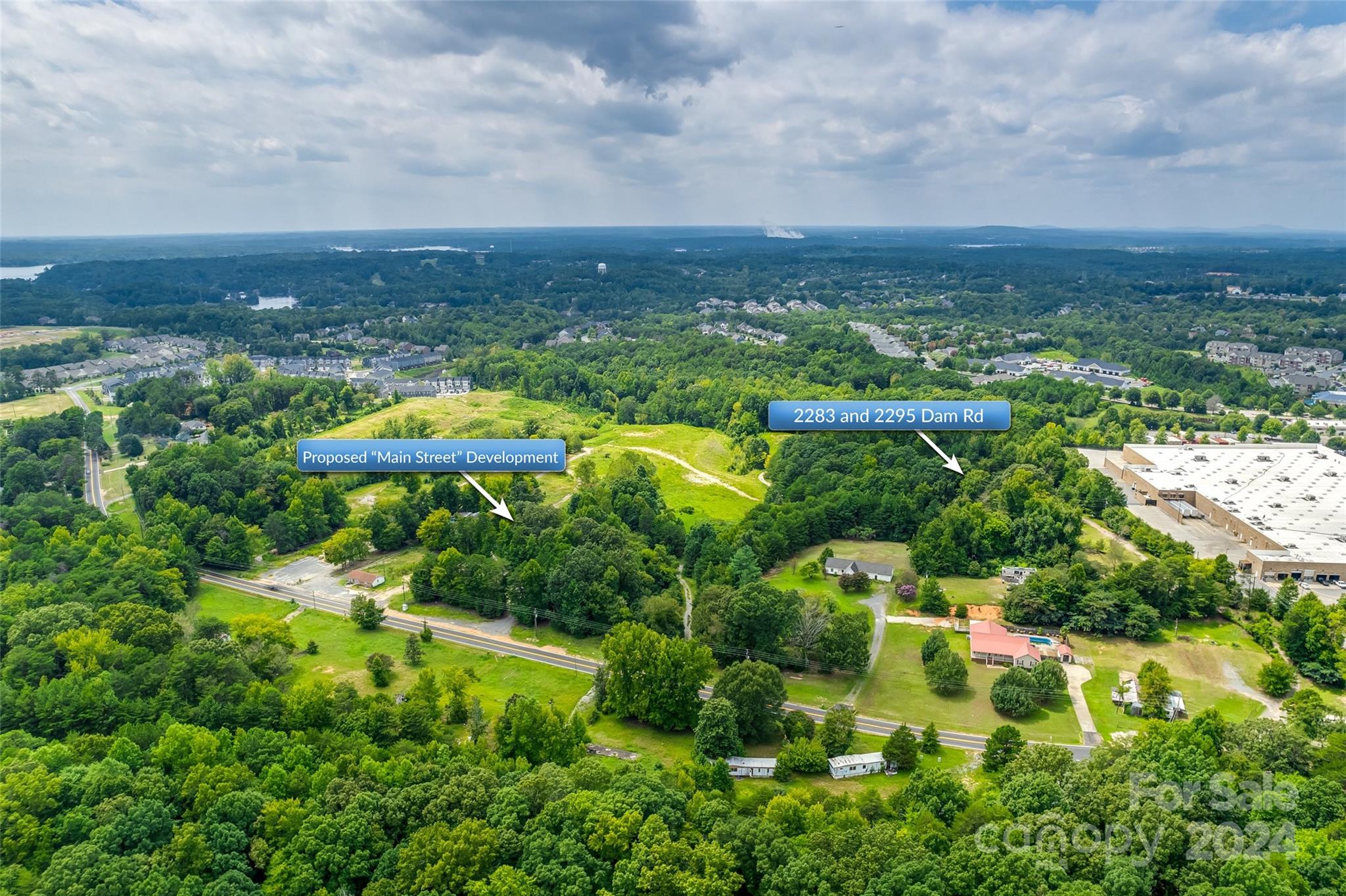 Rare opportunity for developers and investors! Two parcels (644-000-0039 and 644-000-0016) make up a total of 10 +/- acres. This property is adjacent to the Tega Cay "Main Street" development which has broken ground and also runs parallel to Walmart in the Stonecrest Shopping Center. The property is roughly half a block off Hwy 160 on Dam Rd and has approximately 630 feet of road frontage. Currently zoned RUD and will require rezoning for highest and best use. Property will need to be annexed to Tega Cay since water and sewer services provided by the City of Tega Cay. Two dwellings and miscellaneous buildings will convey as is and at no value. The property is also advertised for sale in the Lots/Acres/Farms section of Canopy MLS #4173849. Buyer responsible for land test, survey, and rollback taxes if any. Buyer agent should verify any important information.