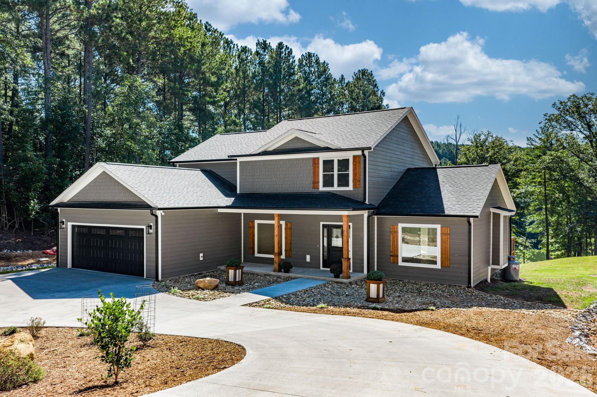 LAKE FRONT NEW CONSTRUCTION on Lake Rhodhiss! Beautiful  Five Bedroom 4 1/2 Bath 4600+ sq ft Custom Home. It is rare to find a completed spec home where the builder/owner has thought about so many details in regards to the daily function of the home. This home has those characteristics. As you pull down the driveway you will note the landscaping. Approaching the home you will note that a significant amount of level area was created for the home and the front and back yard. Note that the septic system is on the right side of the yard preserving the back yard for a potential swimming pool. From the front porch step inside an area that flows beautifully for daily life or entertainment/gatherings. The Living Room is focused toward a beautiful gas fireplace.  Step around to the breakfast nook with windows overlooking the lake. The kitchen has custom built Hickory cabinets hand crafted by Wise cabinet shop. Open the doors to the pantry cabinet.  Step down the hall past a half bath for guests and a laundry passage that leads to the garage into a large Primary Suite.  Heading upstairs not the landing at the top of the stairs large enough for a sitting area. This floor features three large bedrooms two bathrooms one being a Jack and Jill. The lower floor has another complete kitchen, another living space, a Recreation area, a Bedroom a luxuries bath and a heated and cooled utility/storage area. Walk out of this lower area to a gentle walk to the lake.  The owners have been told that the property can be permitted for a dock and have measured water in excess of 20 ft in depth.  Paradise Harbor is privately located but only minutes to I-40 and is between Morganton,  and Hickory.