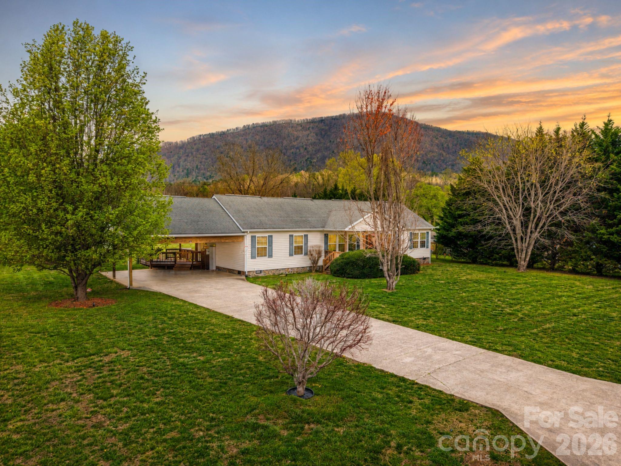 Back on the market due to the previous buyer's financing falling through—not because of the property's condition. The sellers have proactively completed numerous inspection-related improvements, making this home an even stronger opportunity for its next owner. Nestled at the foot of the Blue Ridge Mountains, this inviting home offers one of its most sought-after features in Western North Carolina—a spacious, flat yard that's ready to be enjoyed. Whether you're gardening, entertaining, playing with pets, or simply relaxing outdoors, the level lot provides space that's increasingly hard to find in a mountain setting.

Inside, you'll find a bright, comfortable layout with vaulted ceilings, abundant natural light, and a desirable split-bedroom floor plan. The versatile den offers additional living space that can easily serve as a family room, home office, media room, or hobby space, while the open living and dining areas create an inviting flow for everyday living.

Step outside to enjoy the covered front porch, private back deck, mature landscaping, and fenced backyard—all designed to make the most of the peaceful surroundings and mountain backdrop.

With many recent improvements already completed and convenient access to Old Fort, Marion, Black Mountain, Asheville, hiking trails, and outdoor recreation, this home offers the perfect combination of comfort, functionality, and mountain living.