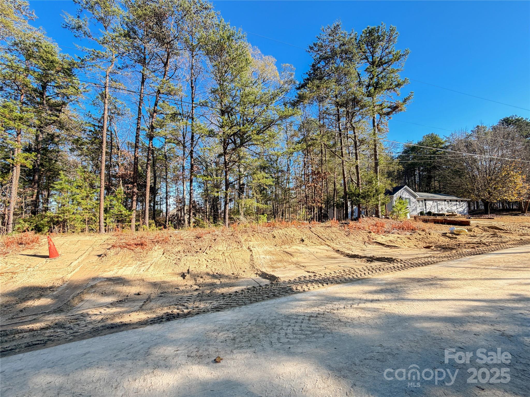 This Opportunity Features City Water & Sewer Taps Already in Place, A Rare Find For This Area - Over 17k In Savings. Discover the perfect blend of nature, convenience, and possibility at 17307 Green Hill Road. This beautiful vacant lot is nestled among mature trees and is just minutes from Lake Wylie’s boating, fishing, and waterfront recreation. The Palisades community—featuring golf, tennis, a private country club, walking trails, and fitness facilities—sits right around the corner. Here, you’ll enjoy a peaceful residential environment with easy access to everything southwest Charlotte has to offer. Whether you're looking to build now or secure a prime piece of Charlotte real estate for the future, this property delivers location, privacy, and long-term value.