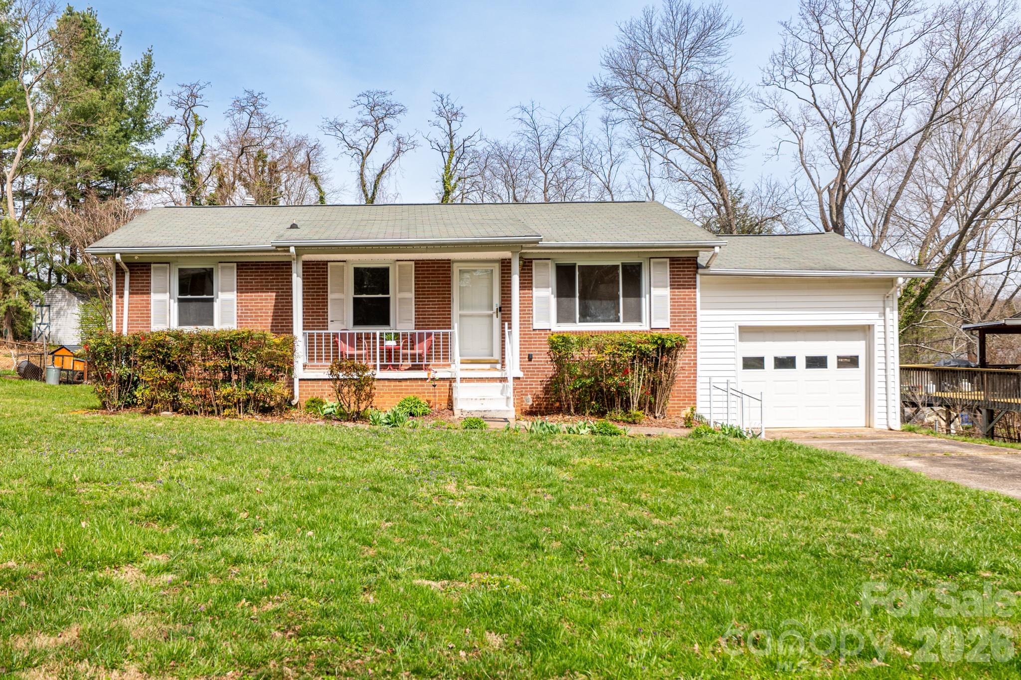 SELLER IS OFFERING A 2-1 BUYDOWN WITH AN ACCEPTABLE OFFER TO HELP YOU SAVE HUNDREDS ON YOUR MONTHLY PAYMENTS FOR THE FIRST TWO YEARS! Start your mornings on the inviting covered front porch of this classic 4-bedroom, 1-bath ranch offering 1,577 sq ft of comfortable living space. Located in a well-established West Asheville neighborhood just minutes from Patton Avenue and Haywood Road, this lovingly maintained one-owner home—built in 1967—blends timeless character with exciting potential for its next chapter. Inside, pristine hardwood floors run throughout the main-level living areas and bedrooms, adding warmth and charm. The full bathroom preserves a delightful mid-century touch with its original Tiffany-blue tiled tub and shower surround. In the eat-in kitchen, freshly painted off-white cabinetry brightens the space while honoring the home’s original character—making it a welcoming hub for everyday meals and gatherings. In addition to the 950-square-foot main level, the partially finished basement adds an additional 627 sq ft of heated living area, including a spacious den and a generous fourth bedroom. French doors open from the den to a large 220 sq ft covered back porch—an ideal spot to relax while overlooking the private, fenced yard, which is ready for your ideas. Whatever outside oasis you're dreaming about, this yard has more than enough space to make it a reality. Just off the den is a spacious laundry room with built-in shelving, which is perfect for dry-goods storage. At 323 square feet, there's also room for a second refrigerator, a small home gym, workshop, or creative studio. Completing the property is a single-car garage and a driveway with parking for two additional vehicles. Full of charm, character, and possibility, this well-cared-for West Asheville home is ready to welcome its next owner. Schedule your showing today and come experience its warmth and potential for yourself. BE SURE TO WATCH THE WALK-THROUGH VIDEO. https://youtu.be/-S8qPJnuimA