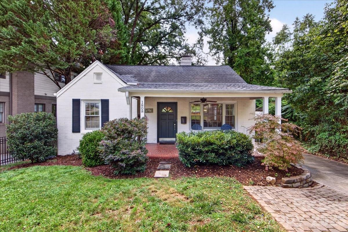 Welcome to 1808 Truman Rd, an updated home brimming with curb appeal and character on an idyllic Plaza Midwood street. From the welcoming rocking chair front porch, enter into the light-filled living room with a gas fireplace and custom-painted accent wall. Charming archways frame the fireplace and lead to the kitchen and dining room. The kitchen has tons of cabinet and counter space, brand new quartz countertops, stainless steel appliances, and a sleek tile backsplash. Just off the kitchen, the spacious laundry room can double as a walk-in pantry and storage space with a utility sink. The main level primary bedroom features an updated designer ensuite bathroom with an oversized shower and custom closet. A secondary bedroom with wainscoting and the second full bath complete the main level. Upstairs, the third bedroom features charming exposed brick and enough additional space for an office, workout room, or den. Outside, the deck off the kitchen and the paver patio with firepit are the perfect places to gather. The unfinished basement spanning most of the home provides incredible storage. Additional highlights include fresh paint throughout, hardwoods and tile on the main level, brand new carpet upstairs, updated lighting & ceiling fans, a painted brick exterior, EV charger (2022), and new roof (2025). Offering the perfect blend of charm, updates, space, and flexibility, this home is just moments from Plaza Midwood favorites like Plot Twist, Resident Culture, Calle Sol, Giddy Goat, Clark's Snack Bar, and more. Welcome home!