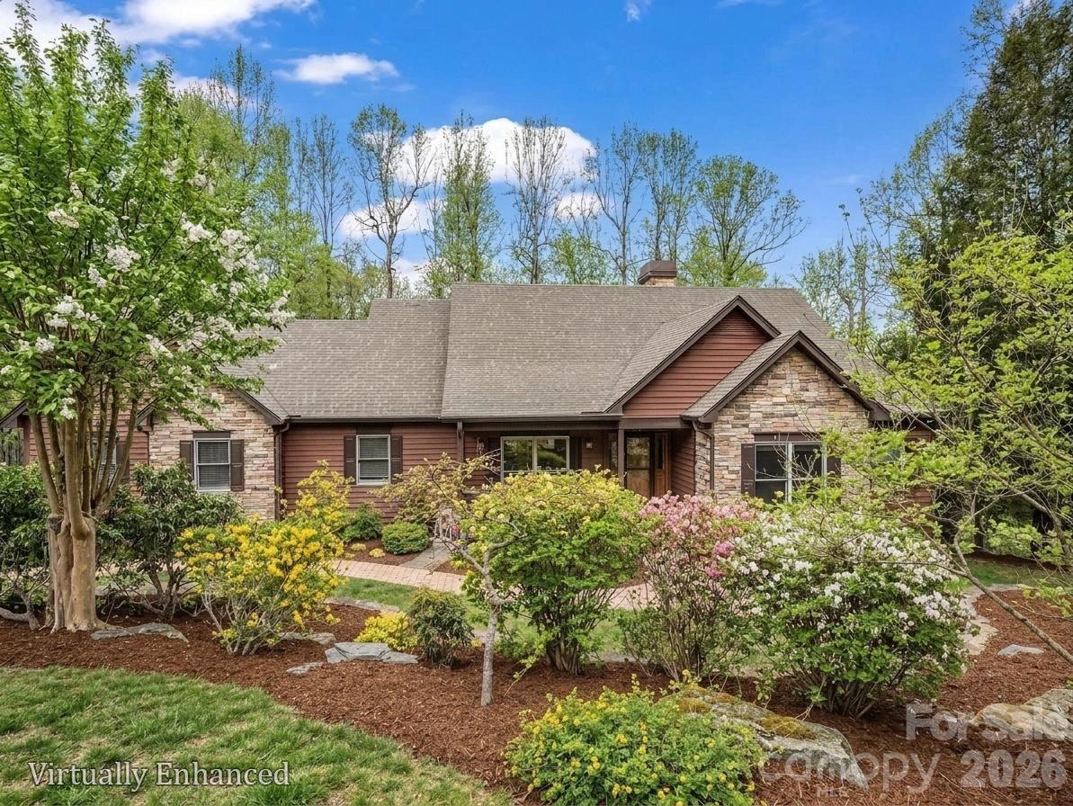 Stunning, well-appointed, pristine home situated in one of the best kept secrets in Hendersonville, Pathways of Solomon Jones, a small enclave of luxury mountain homes within close proximity to Hendersonville and Flat Rock! Pathways of Solomon Jones strives to keep the natural state surrounding its current 43 homes intact, with each having 2 to 5 acres of land, protecting the privacy of its homeowners. This meticulously maintained, 3 bedroom, 3 bath home is set on over 2 acres and is the perfect in size for those wishing to age in place yet have room for family and friends to stay awhile. The main living area has a beautiful, vaulted, beamed ceiling, built in bookcases, and a dramatic, soaring fireplace for cold winter nights. Warm oak floors and new wood doors throughout the main level create that mountain ambiance so many desire. Light streams through its many windows and doors which lead to the large deck with winter views. The gourmet kitchen, featuring high quality cabinetry, leathered granite countertops, double ovens and a walk-in pantry, flows seamlessly into the dining and living rooms making it ideal for everyday living or entertaining. The primary bedroom provides access to the deck as well to take in the surrounding beauty and has an ensuite bathroom with a double leather granite countered vanity, separate shower and garden tub.  The guest bedroom on the main floor could be used as a bedroom or an office, with private access to the second full bathroom, also accessible as a hall bath. The laundry room is also on the main level and offers a sink and pull-down ironing board! Every window beckons one to spend time basking in the magnificent landscaping all around the home with limited grass to maintain. The lower level offers a family room with built-ins for setting up a home office or enjoying a movie. The French Door from the family room provides access to the flagstone patio and paths meandering through the beautifully landscaped flower beds. An additional bedroom, full bath and second bonus room for whatever your heart desires, provide a private oasis for family and friends.  An unheated fitness room is also available for staying in shape from home. And there is plenty of additional unfinished space for one wishing to expand. For those desiring to have access to amenities, guest memberships are available through the Champion Hills and Hendersonville Country Club. A mere 5 minutes down the road is Champion Hills, known for its award-winning Fazio Golf Course, ranked 47th in the US on Golfweek’s 2026 list. Members also enjoy a wellness center, pool, tennis, pickleball, walking trails and upscale and casual dining available through Champion Hills. Hendersonville Country Club is also less than 15 minutes away and offers golf, tennis, pickleball, a pool, fitness center and dining for its members. The charming town of Flat Rock is 17 minutes away. Downtown Hendersonville, just 15 minutes away, was touted by the New York Times as the “City of Four Seasons,” sits on the edge of the Blue Ridge Mountains. It is home to over 200 apple growers with close proximity to world class hiking and bike trails and is known as a quaint, family-friendly town! It was named “Best Retirement Town” in 2023 and continues to attract newcomers both young and old. Hendersonville also offers a variety of medical care options including three hospitals: Advent Health, Pardee Hospital and South Asheville ER. Come and see this home and experience what it feels like to be on vacation all year long! The best way to get to the house is to GPS to One Hagen Drive and then this address.