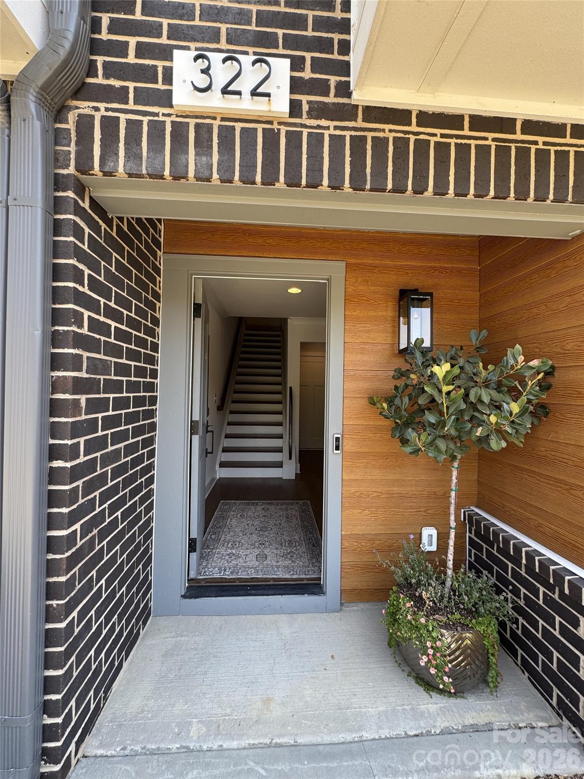 Beautiful townhome in LOSO featuring 3 bedrooms plus loft, outdoor rooftop terrace, and 2 car garage with side by side parking. Completed in 2024 this home has many upgrades and improvements including hardwood floors throughout the open floorplan, epoxy flooring and built in cabinets in the garage, dramatic upgraded light fixtures, automated window blinds, upgraded appliances including microwave drawer and refrigerator with dual ice makers, built in dry bar in loft with 2 beverage coolers, custom built-in closet in primary bedroom and much more. HOA with no rental restrictions. This home is within a short distance to the Brewery District as well as the Blue line, popular Rail Trail, LoSo Village and an easy drive to Uptown, Park Road Shopping Center and South Park. Don't miss out on the opportunity to call this home yours.