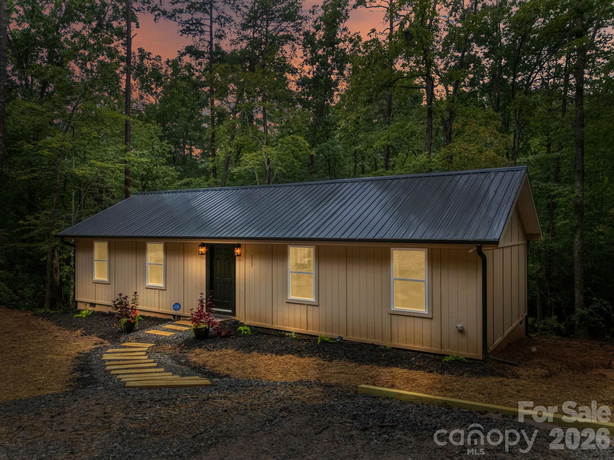 MOTIVATED SELLER. Discover your perfect secluded Lake Lure escape in this brand-new Stick Built one-level home with 2 primary bedrooms, 2 large walk-in closets on 0.55 acres in Riverbend At Lake Lure. Step inside to a bright, open-concept layout with stylish finishes including bamboo hardwood, tile, and carpet floors. The home has LP siding and a durable metal roof. Move-in ready with all brand-new furniture and home decor included. Enjoy the sounds of a nearby stream from the back deck. Spend your mornings kayaking on Riverbend’s private Big Mirror Lake or relaxing at the community beach. In minutes, you can be enjoying Lake Lure’s public beach & water park, teeing off at nearby golf courses, or exploring Chimney Rock State Park. Scenic drives on the Blue Ridge Parkway, charming Asheville, and the Tryon International Equestrian Center are all within easy reach. Whether you’re looking for a full-time retreat, a weekend getaway, or a short-term rental opportunity, this home offers the mountain lifestyle you’ve been dreaming of.