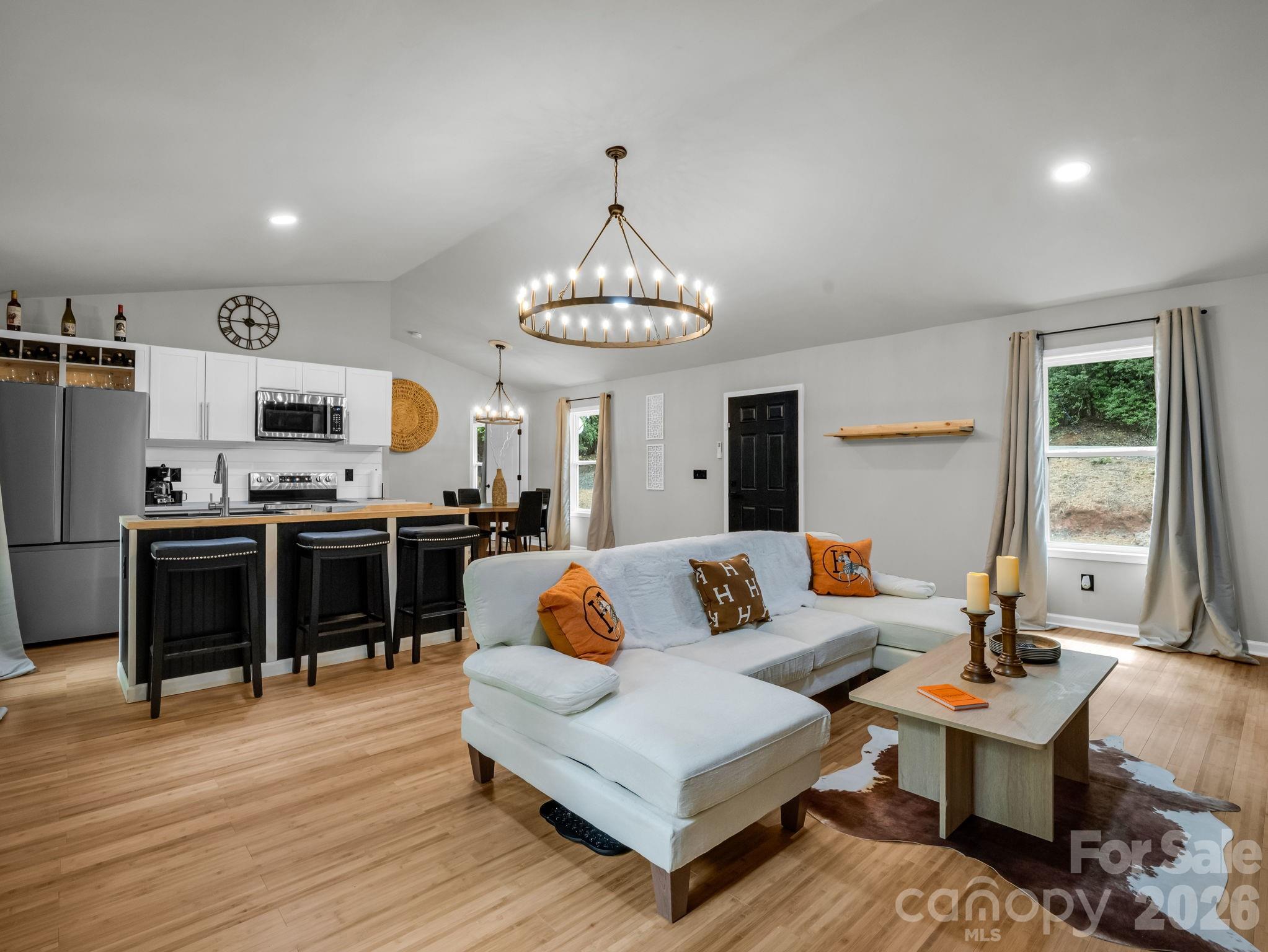 Seller is ready to make a move on this, fully furnished Lake Lure home in Riverbend at Lake Lure.
Enjoy easy one-level living in this newer custom-built home in Riverbend at Lake Lure, set on 0.55 acres in a private mountain setting with convenient access to community amenities and nearby Lake Lure attractions. This thoughtfully designed home features an open-concept floor plan with two spacious primary bedrooms, two large walk-in closets, and comfortable finishes including bamboo hardwood, tile, and carpet flooring. Durable LP siding and a metal roof provide low-maintenance exterior appeal, while the bright interior offers a warm, move-in-ready feel.

Furniture and home decor are included, making this an appealing option for a full-time residence, weekend retreat, or potential short-term rental opportunity. Enjoy Riverbend’s private Big Mirror Lake, community beach, walking trails, and peaceful natural surroundings. Just minutes away, you’ll find Lake Lure’s public beach and water park, Chimney Rock State Park, area golf courses, scenic mountain drives, and dining and shopping in nearby Lake Lure and Chimney Rock. Asheville, the Blue Ridge Parkway, and Tryon International Equestrian Center are also within easy reach. A wonderful opportunity to enjoy the Lake Lure mountain lifestyle in a newer, furnished, move-in-ready home.