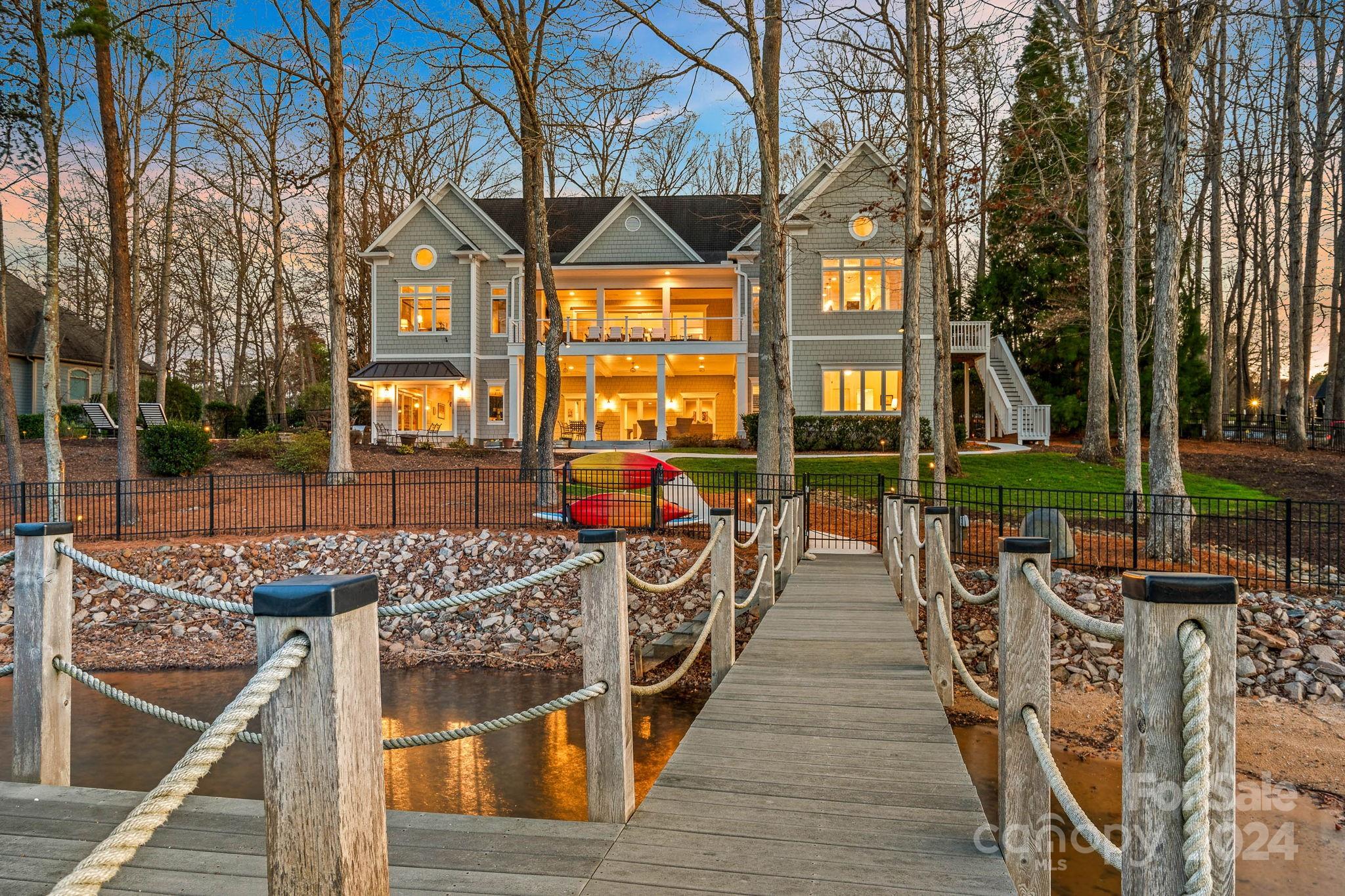 Indulge in upscale lakeside living within the prestigious Point Community. This stunning ranch-style property offers breathtaking views of Lake Norman.  After a day of boating on the water, return to your private dock and unwind in the lakeside pool or enjoy the warmth of the hot tub by the fireplace on cooler nights.  Step inside to find a newly updated great room offering inviting lake views, while the main level porch, complete with a fireplace and retractable screens, invites relaxation. The kitchen and dining area, featuring an expansive island and top-of-the-line appliances are perfect for entertaining guests. Delight in fireside dining with a view of the water. Later, retreat to the basement for billiards or ping pong—endless entertainment awaits. The renovated secondary primary bedroom and bathroom in the basement provide a tranquil sanctuary for guests and family.  Create lasting lake memories in this remarkable home—seize the opportunity now!