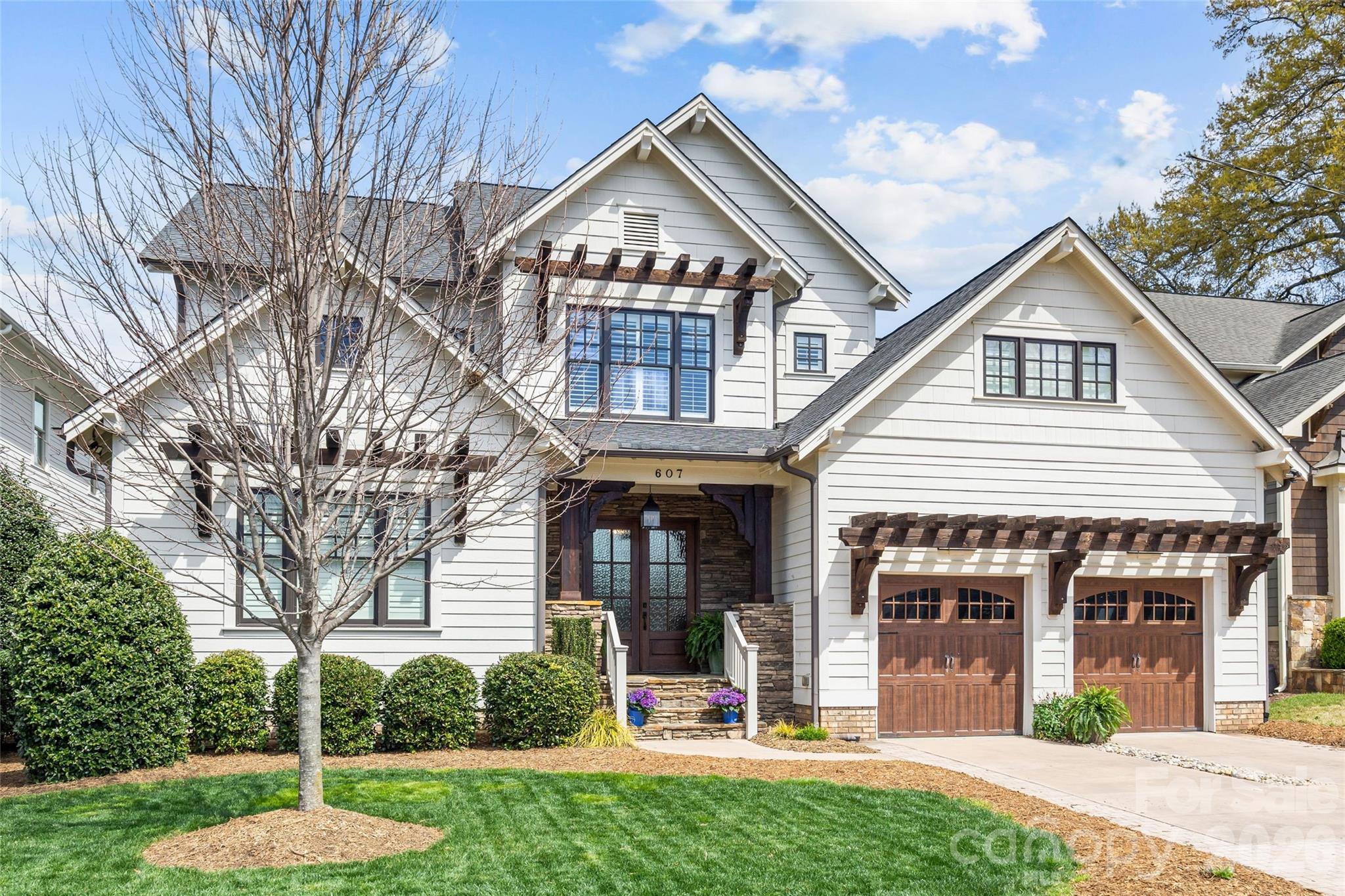Nestled in the heart of Dilworth is this stunning, custom home built in 2018 by Crescent featuring 5BR/5BA, 10’ ceilings on both levels, hardwoods throughout, and exceptional design with high quality finishes. Open-concept on the main level living combines with seamless indoor-outdoor flow to a private outdoor oasis. Chef’s kitchen with oversized island, quartzite & butcher block countertops, Sub-Zero/Wolf appliances, 48” range, wine tower, scullery, and butler’s pantry is perfect for entertaining. Luxurious primary suite on main with vaulted ceilings, wet bar, laundry, and expansive custom closet, and  oversized spa bathroom. Complete with vaulted office/guest suite on main with full bath. Upstairs offers 3 bedrooms/bathrooms, bonus room with cabinetry & beverage fridge, study loft and 2 generous sized walk-in attics that can be easily built out for additional living space. Enjoy a vaulted covered porch, brick paver patio with grilling station & firepit opening to a private flat yard with room for a pool. The perfect home with the perfect location in Dilworth,  just minutes from Uptown, offering a rare blend of historic charm and walkable urban living, with easy access to top dining, shopping, parks, and Charlotte’s premier sports and entertainment venues.