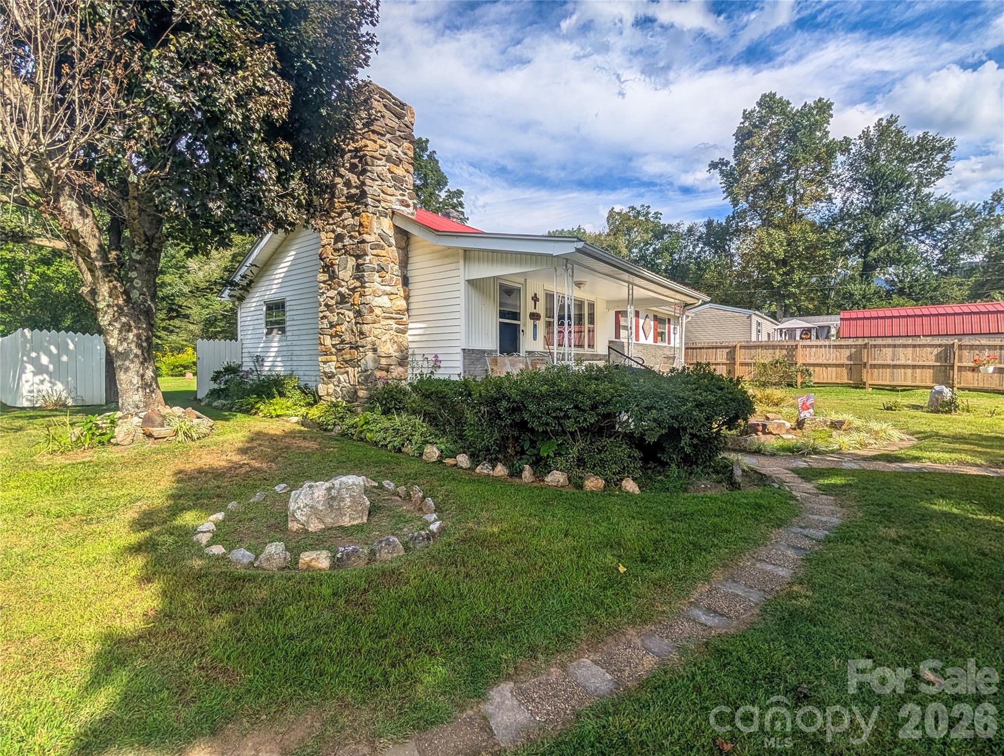 Scenic Homeplace - where you step back in time to a place that feels like going home to Grandma's!  This 3BR/BA one-level home rests on a 2.74 level acres with room for a garden, mini-farm or simply enjoying wide open space.  Inside you will find cozy paneling, hardwood floors in living room and bedrooms.  Living room has native stone wall/hearth for Fisher wood-burning stove and opens into dining/kitchen where family and friends gather. Electric wall oven/range top plus refrigerator included (DW does not work). The laundry/utility room doubles as extra work space for kitchen and includes separate sink for preparation of food. A favorite space for everyone is the cheerful sunroom off kitchen/utility room.  Property includes wood 2-car garage w/storage area, plus a separate metal carport for extra storage. A separate small building is ideal space for Artist Workshop or your hobby,sewing room or creative space.  Enjoy outstanding views of the Cattail Mountains as your scenic backdrop -- a peaceful mini-farm and a true "get back to nature" retreat.  While property lies in the floodplain, flood insurance is available, making this a practical investment, as well as a charming one! Don't miss this great buy ---only $335,000!