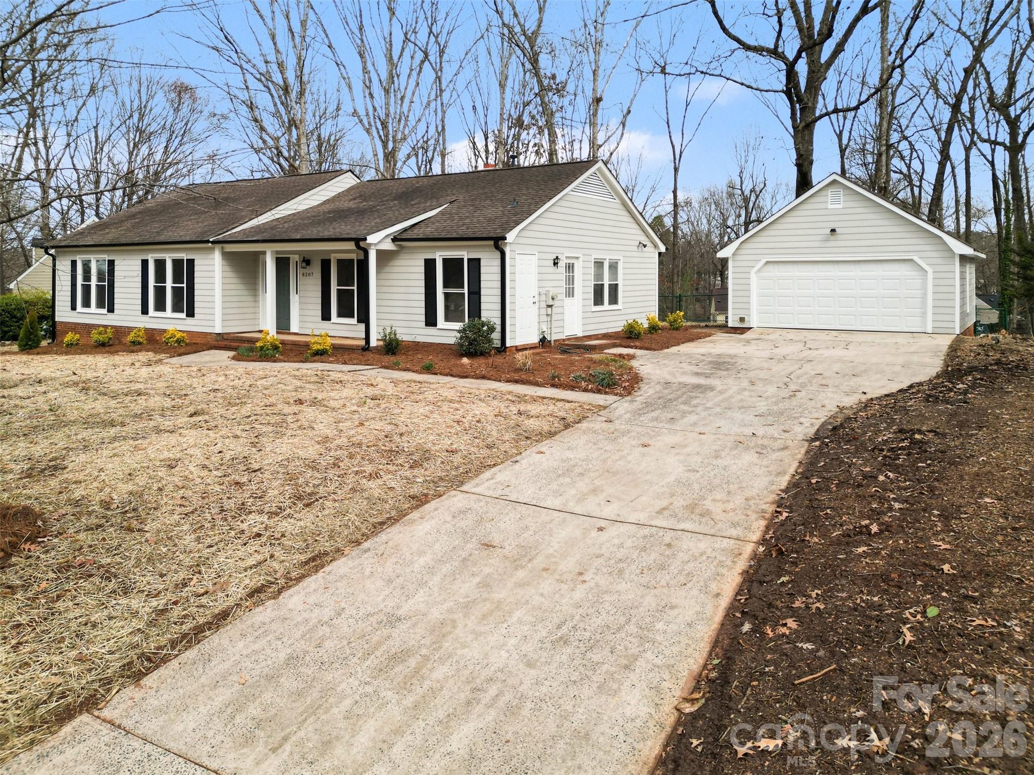 Located in an established neighborhood just minutes from downtown Matthews, this beautifully updated 3 BR, 2 BA home offers space, charm, and an unbeatable location. Set on nearly half an acre, the fully fenced back yard provides privacy and plenty of room to relax, garden, or entertain.

Inside, you will find a fresh, modern feel with thoughtful updates throughout. The kitchen has been freshly renovated with new cabinets, quartz countertops, stylish backsplash, and brand new appliances. New vinyl flooring enhances the kitchen and bathrooms, while new carpet adds comfort in the bedrooms. Both bathrooms feature new vanities, mirrors, toilets, updated lighting, and a new tub and shower surround in the hall bath. Fresh interior paint, updated light fixtures, and new closet and pantry shelving make the home truly move in ready. The exterior has also been freshly painted for great curb appeal.

The spacious primary bedroom offers a comfortable retreat, and the generous living area is centered around a cozy wood burning fireplace. A covered front porch and rear patio create inviting outdoor living spaces, while the detached two car garage with dedicated work bench area provides ample parking and storage.

Located approximately one mile from charming downtown Matthews and just minutes to Providence High School, The Arboretum, Carolina Place, and I-485, this home combines everyday convenience with the character of an established community. With major updates already completed, this is a fantastic opportunity to enjoy a refreshed home on a large lot in one of the area’s most desirable locations!