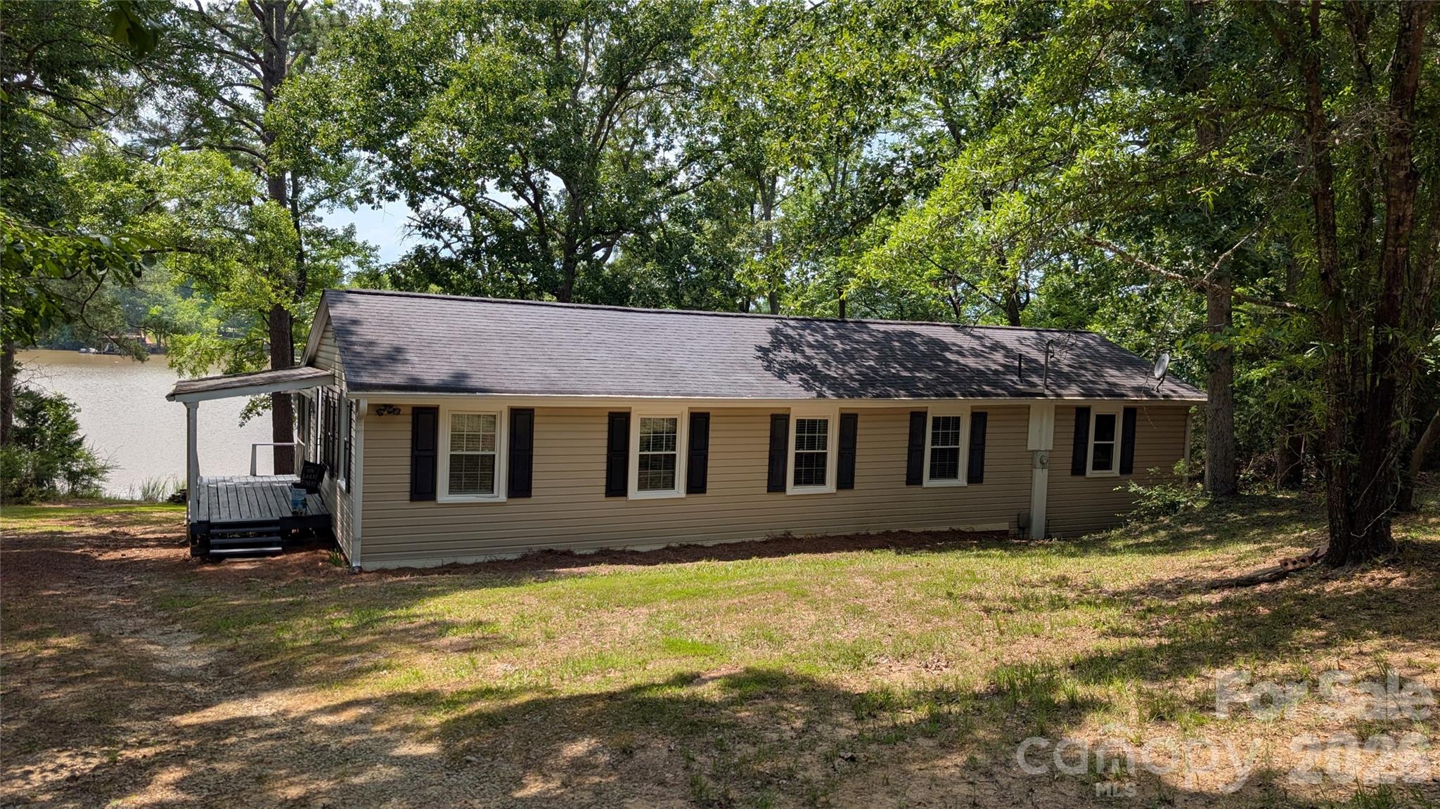 Perfect weekender or permanent residence on Lake Wateree! 3 bedrooms, 1 bath on a spacious 0.72 acre lot with 178 feet of water frontage. Deep water at dock. The Home has a great open floor plan and a huge lakeside screen porch with room for all your friends and guests. Also enjoy the lakeside kitchen / bar area. Perfect for   cooking out, entertaining, watching the game, etc. Recent improvements include a transferable termite bond, vapor barrier installed and a clear termite letter. Bring your boats and floats and come enjoy this awesome lake home! Disclaimer:  CMLS has not reviewed and, therefore, does not endorse vendors who may appear in listings.