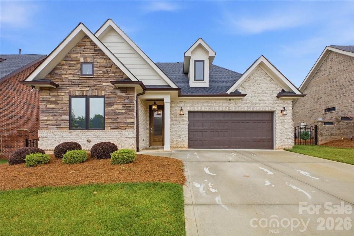 Luxury, Low-Maintenance Living in The Springs at Westport! This exceptional custom brick-and-stone ranch offers true one-level living with no interior stairs and an impressive blend of elegance, comfort, and thoughtful design. The open-concept floor plan showcases 9-foot ceilings, rich hardwood floors, designer lighting, custom cabinetry, built-in storage solutions, and upscale finishes throughout. The stunning great room features a soaring vaulted ceiling, floor-to-ceiling stone fireplace, custom built-in display cabinetry, and illuminated crown molding that creates a warm, sophisticated ambiance. The chef-inspired kitchen is designed for both everyday living and entertaining, featuring custom cabinetry, quartz countertops, a large center island, GE Profile appliances, under-cabinet lighting, and an incredible walk-in pantry with custom shelving and abundant storage. Throughout the home, thoughtfully designed custom closet systems, built-in shelving, and organizational features maximize both functionality and style. The dedicated office is a standout space with floor-to-ceiling built-in cabinetry, a charging station, hidden printer shelf, file storage, and extensive custom shelving. Retreat to the spacious primary suite with a vaulted ceiling, custom motorized window treatments, and a spa-like bath complete with a zero-entry tiled shower, heated towel warmer, dual quartz vanity, and an expansive custom-designed walk-in closet system. A generously sized secondary bedroom offers custom window treatments and access to a beautifully appointed full bath with designer finishes. Enjoy outdoor living year-round on the screened porch featuring a ceiling fan, lighting, built-in speakers, and views of the fenced backyard. The oversized garage is equally impressive, featuring a professionally finished epoxy floor, extensive built-in shelving, hanging storage systems, and exceptional organizational space. Every detail has been carefully considered to provide outstanding storage, including custom cabinets, closet systems, and built-in shelving throughout the home. Residents enjoy access to The Springs at Westport's premier amenities and club membership, delivering an exceptional Lake Norman lifestyle. Move-in ready, meticulously upgraded, and designed for effortless luxury living—this is one of The Springs at Westport's most desirable offerings.