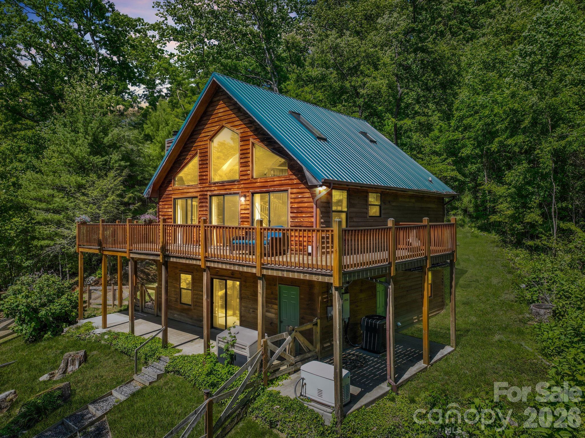 Welcome to your mountain escape — a charming cabin nestled on 2.37 acres of pure, unspoiled nature in the heart of Spring Creek. If you've been dreaming about a place where nature goes on forever and the neighbors don't, this one's calling your name. This spacious 2-bedroom, 2-bathroom home with a bonus loft offers over 2,000 square feet of comfortable living space flooded with natural light. The sunroom is a dream — the kind of spot where your morning coffee just hits different. Step outside onto the wraparound deck and take in those gorgeous long-range mountain views that remind you why you wanted to live out here in the first place. The mature landscaping surrounding the property gives everything a storybook feel, with established landscaping, trees, and greenery that frame the cabin beautifully in every season. Privacy is the real luxury here, and this setting delivers it in spades. It's truly peaceful — just you, the birds, and the breeze through the trees. Practical perks? A whole-house generator means you'll never sweat a power outage, which is a pretty big deal when you're living the mountain life. This home blends rugged charm with everyday comfort and modern amenities in a way that just works. Whether you're looking for a full-time residence or a weekend retreat, this cabin checks all the boxes. Properties like this don't come around often, so come see it before someone else falls in love first.