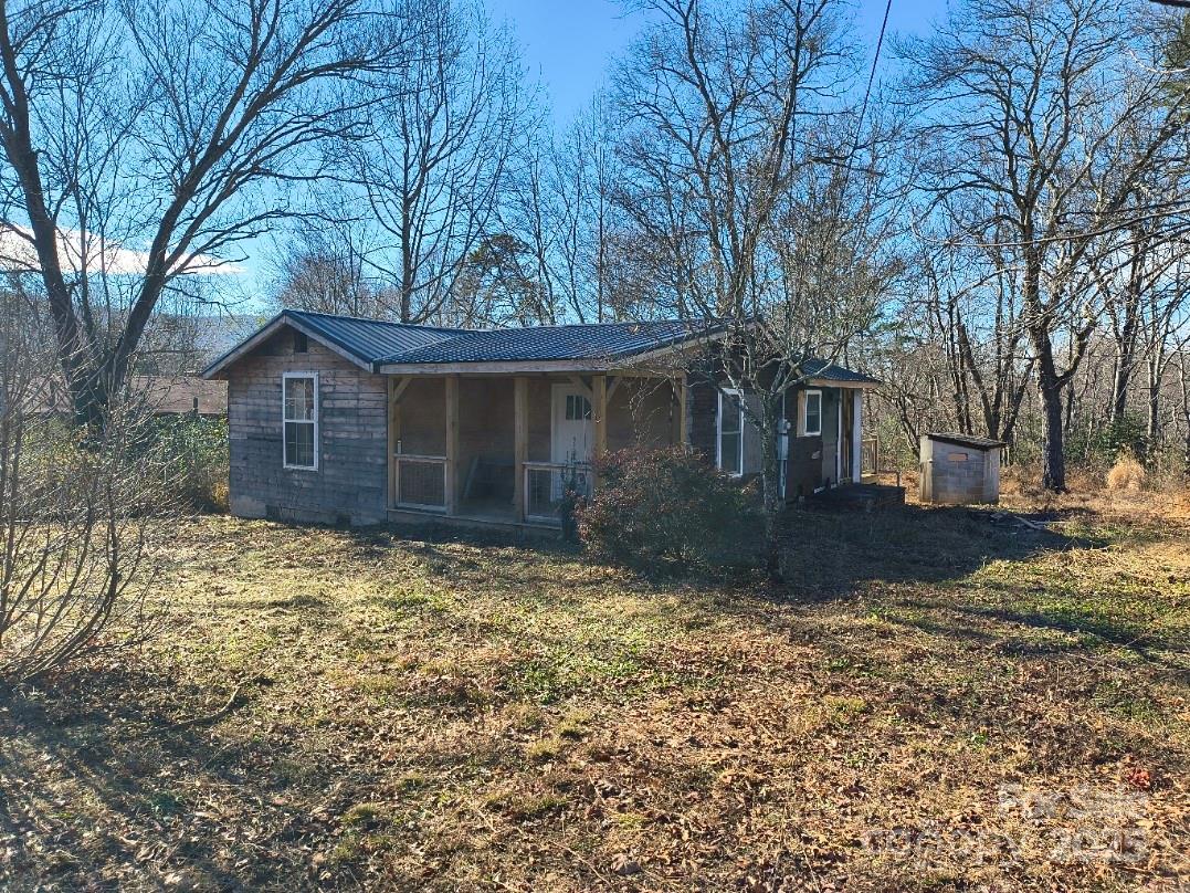 Investment Opportunity! This home is in the beginning stages of a remodel. A metal roof was installed in 2024 and some electrical and plumbing work has been done. Other than that, it's to the studs and ready for your remodel ideas to become a reality. However, that's not where the real value lies. Just 170' (approx) away is the county sewer line. That, along with UR8 zoning could possibly give you 8 more home sites. The land is level near the road and has a gentle slope making building easy for the mountains.