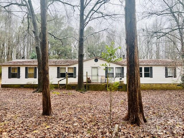 This 4 bedroom, 2 bathroom  home on 4+ acres of land is selling AS IS but has a great split plan floor plan with the potential to shine with some TLC. There is believed to be a second septic tank on the left side of the home where another mobile home used to be. Explore the possibilities of expansion or adding another home on this spacious property. With a little imagination, this property has the potential to become something special. Don't miss the opportunity to create your dream lifestyle. Schedule a showing today! Also listed as LOT MLS 4102061