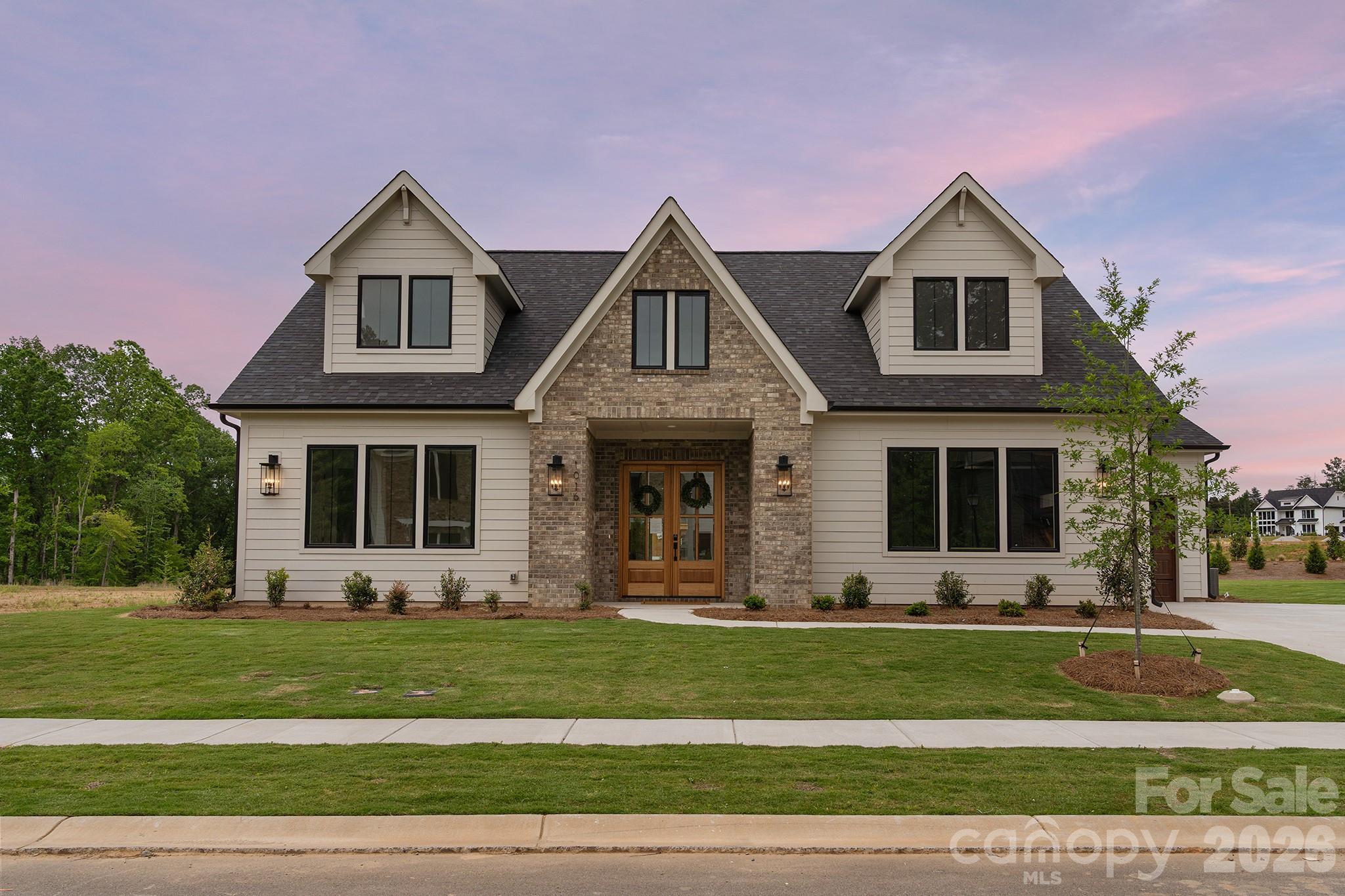 Unwind in luxury with this exquisite 3,665-square-foot home. The expansive primary suite, located on the main level, features a spa-inspired bathroom w/ a luxurious floating tub & an oversized dual-head shower + rain head. The main floor also houses a well-appointed secondary bedroom. Additionally, a versatile office space on the main level ensures that working from home has never been more stylish. This home features an open floor plan, seamlessly connecting the living areas. A chef's kitchen, equipped with top appliances and a generous island. A scullery/pantry with sink, dishwasher and beverage fridge makes hosting a breeze. Upstairs, 2 spacious bedrooms with walk-in closets offer ample storage. Entertaining extends outdoors with a covered patio w/fireplace, ideal for alfresco dining or relaxation. With easy access to Wesley Chapel's vibrant hub of shopping and dining, this home truly represents the pinnacle of affordable modern luxury living. Tour our model and design center & ask about our great lending partner incentive!