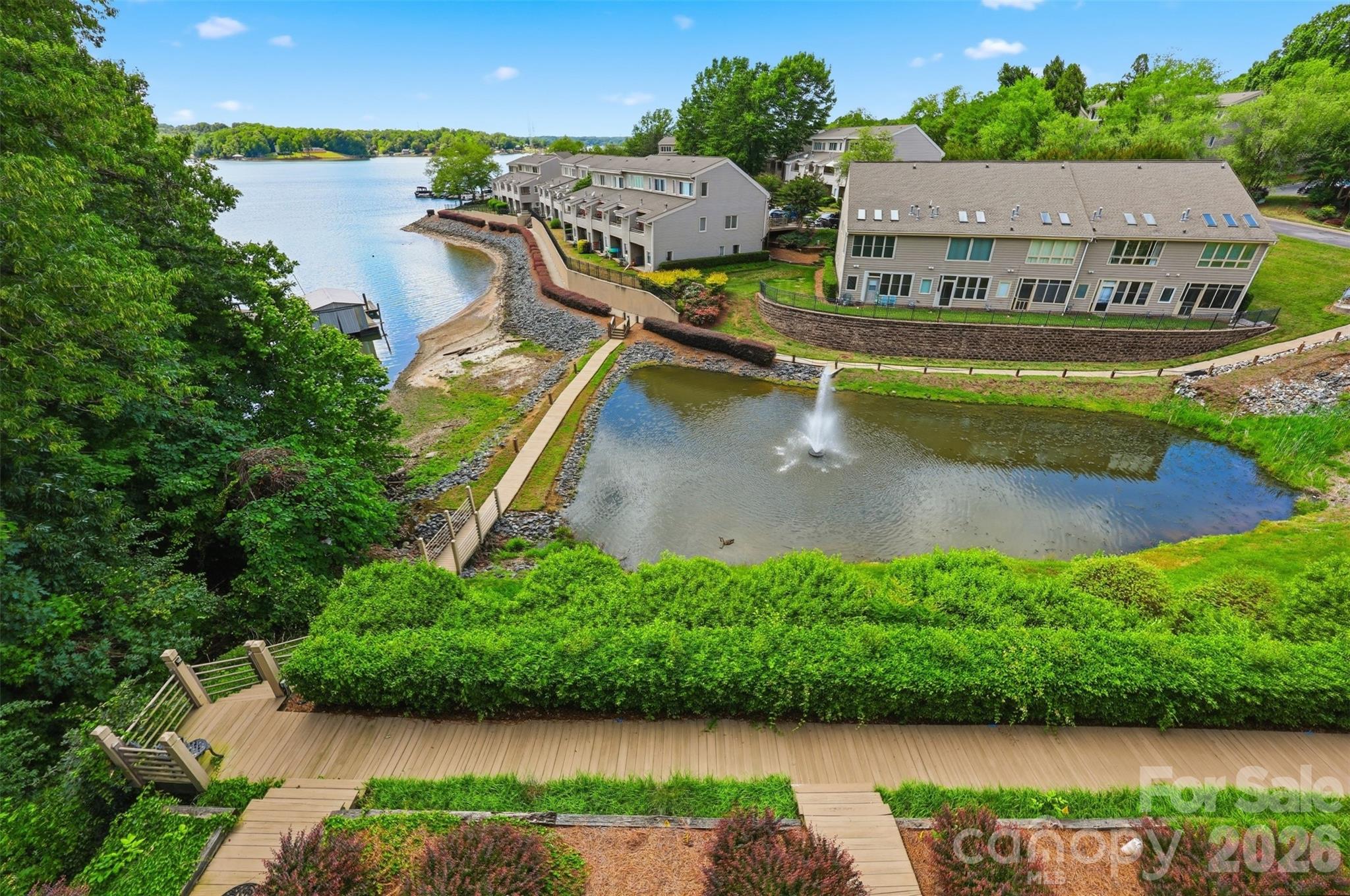 Nestled within the exclusive gated enclave of The Yachtsman, this exceptional lakefront residence captures sweeping, year-round views of Lake Wylie from all three levels, offering a refined take on effortless waterfront living! Residents enjoy a true resort-style experience with access to a private beach, paddle sport launch, pool, clubhouse, tennis courts and so much more, all just moments from home.

Inside, the open-concept main level is anchored by rich hardwood flooring and designed for both everyday living and elevated entertaining. The well-appointed kitchen features granite countertops, stainless steel appliances (updated within the past three years) and timeless cabinetry, flowing seamlessly into the dining and living spaces where expansive water views take center stage. The lower level hosts a spacious primary retreat with durable LVP flooring, direct lake access through sliding doors, and an en-suite with a jetted tub and separate shower, along with a generously sized secondary bedroom and full bath.

The top level offers a private sanctuary — an additional primary suite defined by vaulted ceilings, a walk-in closet, full bath and an expansive deck overlooking the lake and surrounding wooded landscape! Thoughtful updates, including a new roof, water softener and tankless water heater (2025), along with a recently replaced HVAC system (2024), provide peace of mind upon move-in. With the HOA handling exterior maintenance, roofing and landscaping, this home delivers a truly turnkey, low-maintenance lakefront lifestyle!