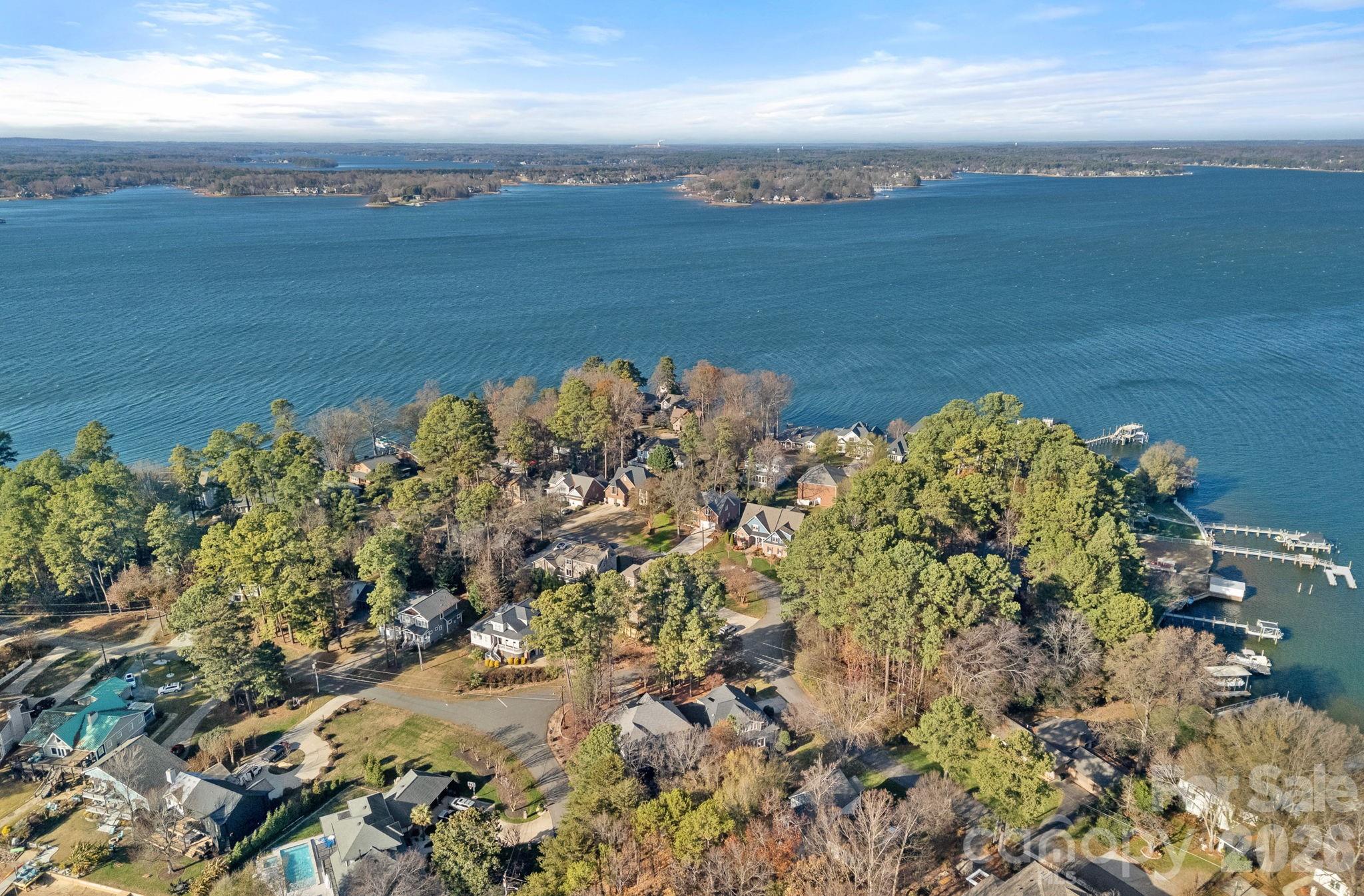 If a meticulously maintained home is what you’re after, this is it! This exceptional single-level home with a finished room over the garage, crafted by ES Johnson Builders, is located in the highly sought-after Island Forest waterfront community on Lake Norman. Positioned on a desirable corner lot with seasonal peek water views, the home offers timeless craftsmanship, coveted lake access, and a thoughtfully designed layout blending comfort and sophistication. The residence features 3-bedrooms and 3-bathrooms, including dual primary suites on the main level, each with a private en suite bath, ideal for guests or multigenerational living. Architectural highlights include a welcoming covered entry, craftsman-style moldings, custom built-ins, solid oak flooring, tall ceilings, and rich maple cabinetry. The open, flowing floorplan provides abundant storage and effortless everyday living, while a fully screened back porch extends the living space outdoors. The upper level offers a versatile bedroom or oversized bonus room with a newly built full bath, perfect for guests, a home office, or recreation space. Thoughtful updates offer peace of mind, including a Trane HVAC system (2019), new roof (2022), tankless water heater (2022), hardwood flooring replacing carpet (2022), fresh exterior paint (2024), and crawlspace encapsulation (2025). Island Forest offers a community dock, boat launch & picnic area located off Montcalm & Island Forest Drive, providing easy access to the Lake Norman lifestyle. Ideally situated just five minutes from grocery stores, dining, coffee shops, and I-77 in desirable Cornelius, this home is truly move-in ready.