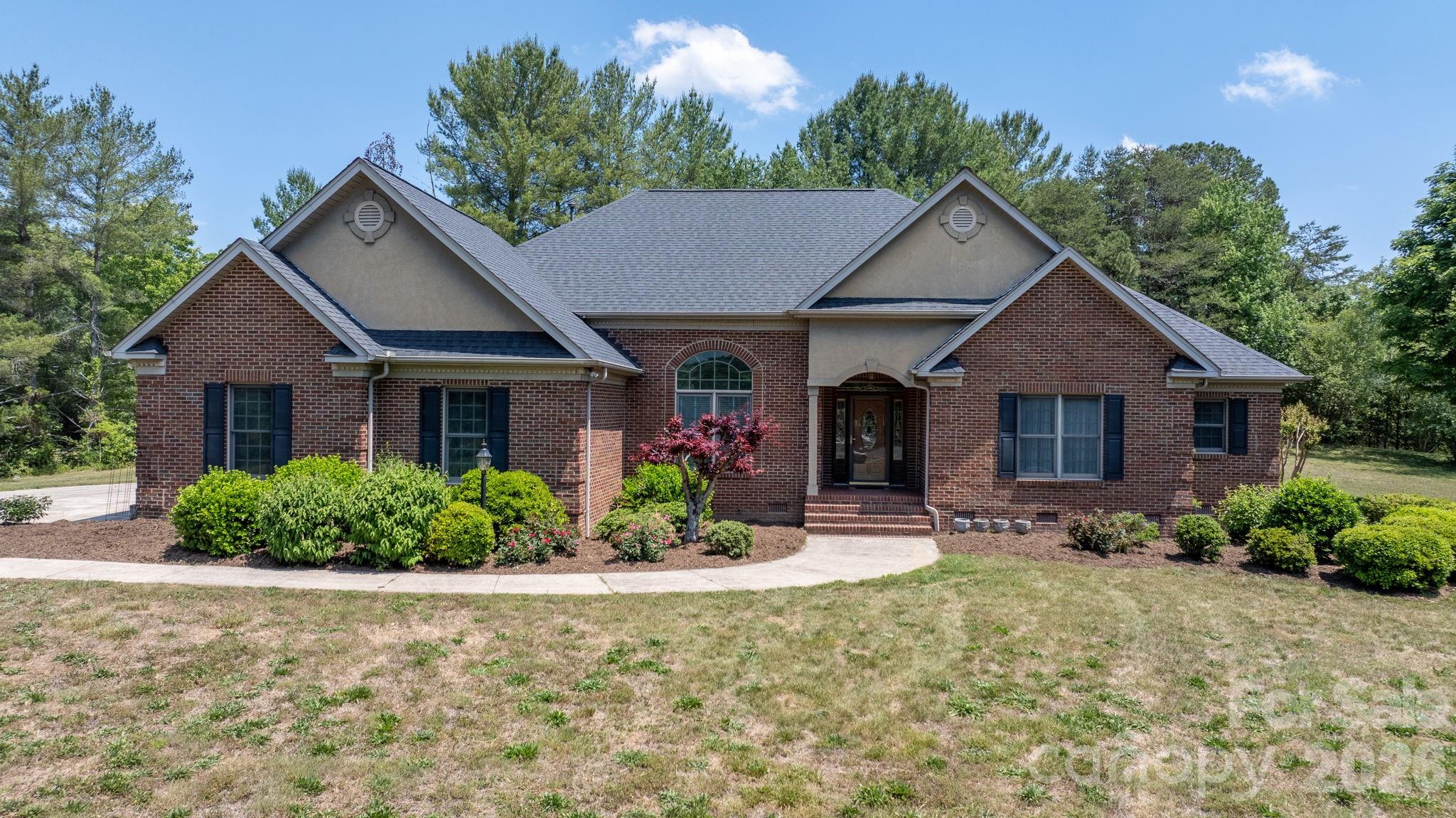 Custom built...One-owner...Solid construction...Full brick ranch...Homes like this do not come around very often! This home was designed with large gatherings in mind. Enter into the foyer that opens into a large family room with built-ins flanking a gas-log fireplace that easily flows into a breakfast area, while just around the corner is a formal dining room for the more intimate meals, both directly accessible from the kitchen. The kitchen is supported by a large walk-in pantry and a versatile utility room with laundry, mud sink, stove and refrigerator connections, plus a discreet half bath within close proximity to the attached garage. At the front of the home is a formal living room that could also serve as an office space. To the rear of the home, the expansive sunroom offers abundant natural light, large windows throughout, and provides access to both a deck and large patio. As you stroll down the hallway, you first come to a 2nd half bath for guests, closet storage, 2 secondary bedrooms with each having private access to a shared bath where the double vanity is separate from the tub/shower. The primary offers an en-suite bath with a double vanity, stand-alone shower, whirlpool tub, private lavatory and a large walk-in closet. Additional features include tall ceilings, crown molding, decorative door and window trim, wood and tile flooring through most of the home, and carpet in the bedrooms. And to highlight the home, the property also features: 3.5 acres of cleared yet secluded land; a detached workshop with 2 drive-in garage doors and 1 with a loading dock, 2400 sqft that has been partitioned into 3 sections to include a kitchen, a half bath, has a new water heater than has never been connected, blown-in insulation and has it's own septic system. There are also 2 working wells on the property while the home is connected to public water. Quality built and intended to last for generations!
