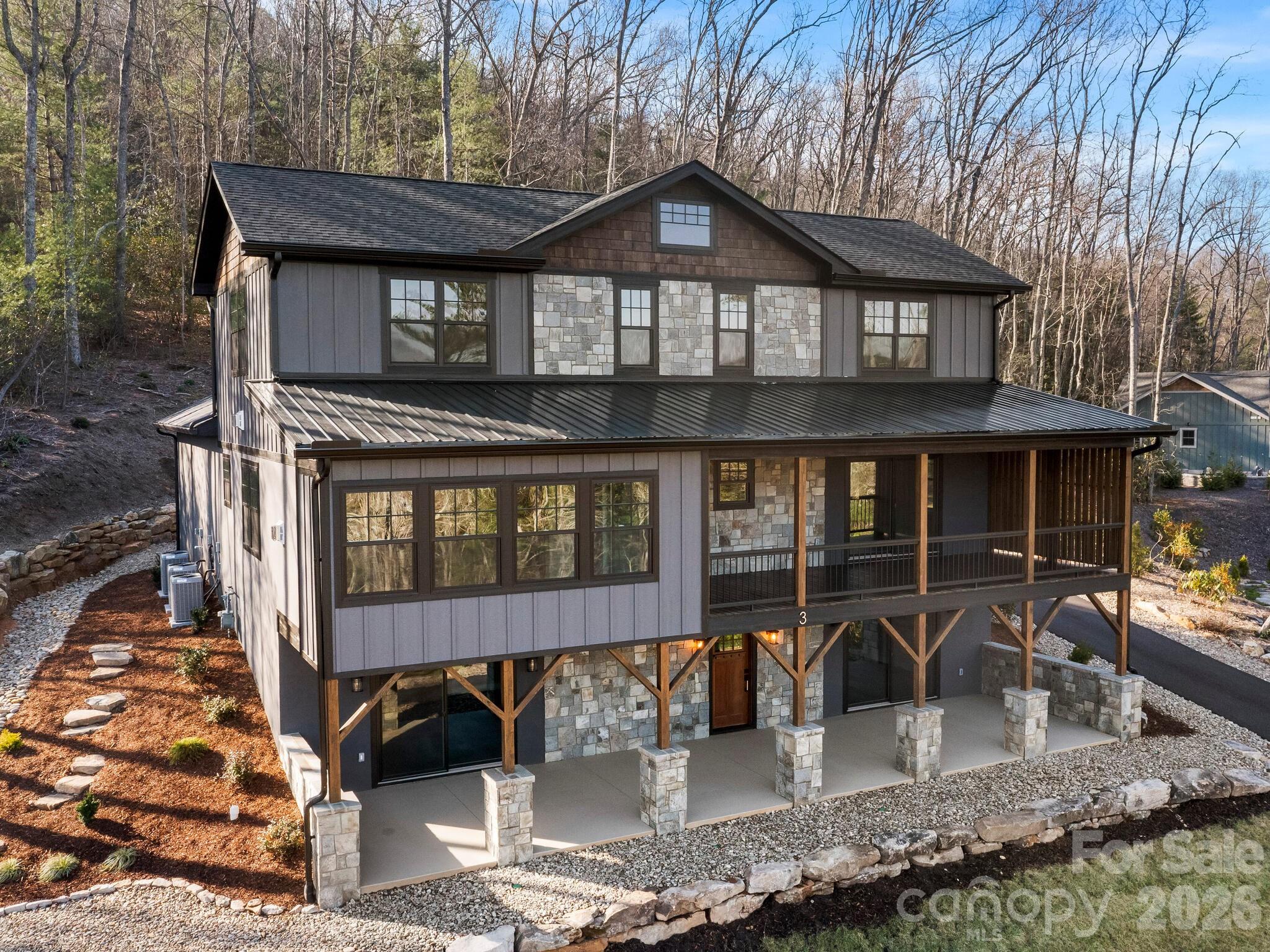 Discover unparalleled mountain living in this exquisite 4-bedroom, 4.5-bath luxury home perched in the beautiful mountains of Fairview, NC. Thoughtfully designed to showcase the breathtaking long-range mountain views, this residence offers refined elegance and exceptional craftsmanship at every turn.
Step inside to open floorplan with expansive windows, and rich natural finishes that create a seamless connection between indoor comfort and the surrounding mountain beauty. The open-concept living area is anchored by one of three stunning 2 gas log fireplaces, offering a warm and sophisticated ambiance perfect for entertaining or relaxing in style. 
The chef’s kitchen features top-of-the-line appliances, custom cabinetry, and an oversized island, flowing effortlessly into the living room and dining area. Each spacious bedroom suite offers its own private bath, ensuring comfort and privacy for family and guests alike.
Step outside to an expansive covered porch with a gas log fireplace where you can take in sweeping mountain vistas or gather around the outdoor firepit for unforgettable evenings under the stars. Additional features include a two-car garage, elegant stonework, and impeccable attention to detail throughout.
Combining modern luxury with timeless mountain charm, this home is a true sanctuary. Whether you're looking for a year-round residence or a peaceful mountain getaway, this home offers the perfect blend of elegance and rustic charm- just minutes away from Asheville's dining, shops, and outdoor adventures.
