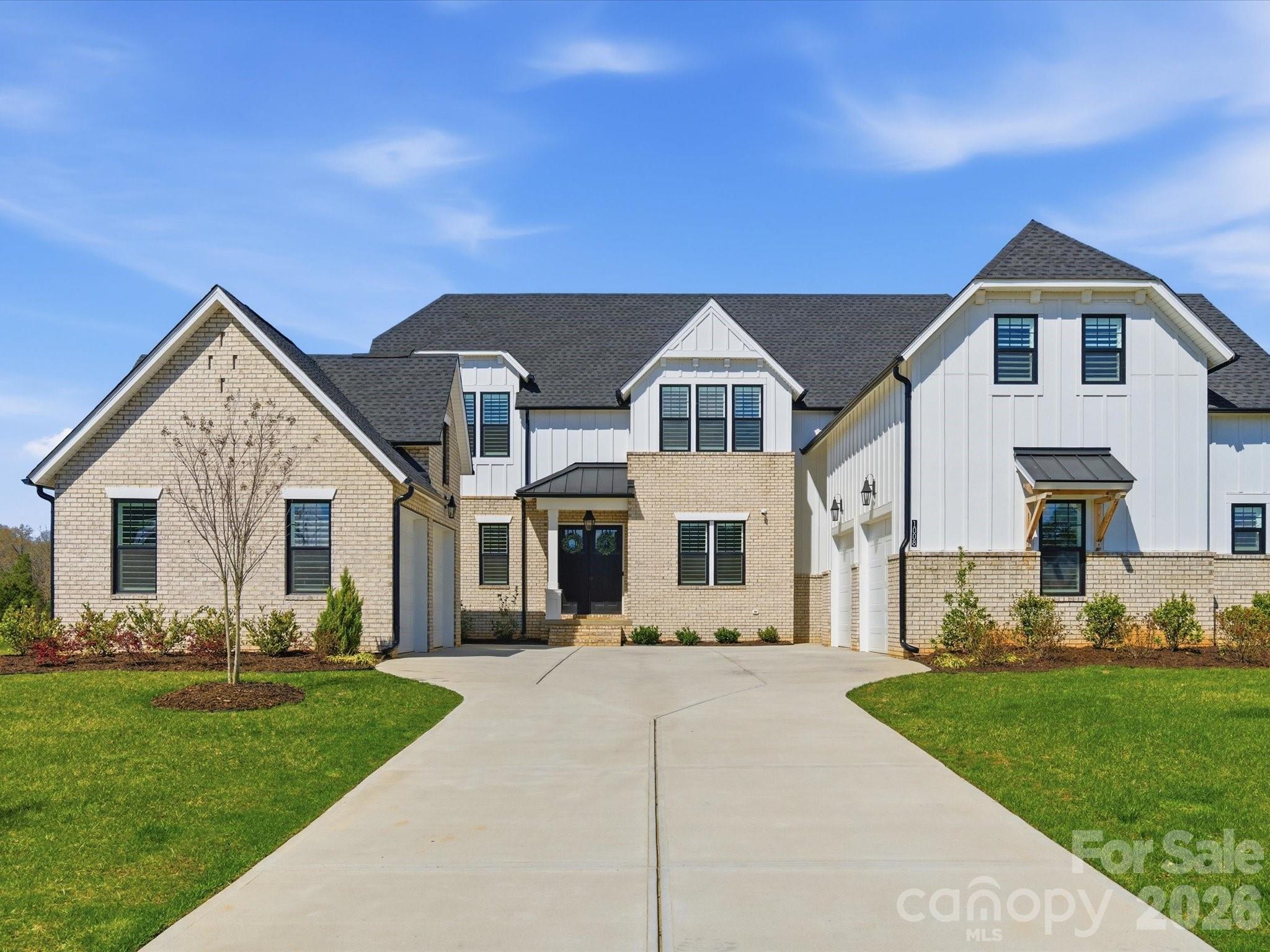 There’s a moment that happens before you even step inside.

As you arrive, the home immediately sets itself apart. Dual garages frame the approach, creating a motor court-style entrance that feels both intentional and elevated. It’s not just curb appeal—it’s a sense of presence that’s rare at this price point.

Step through the front doors, and everything opens.

A wide entry foyer draws you forward into a vaulted living space filled with natural light. A wall of glass stretches across the back of the home, seamlessly connecting the indoors to the covered outdoor living area beyond. Expanded during construction and designed with vaulted ceilings, this space feels open and expansive, yet grounded by warm tones and thoughtful design—striking a balance between scale and comfort that makes the home feel as inviting as it is impressive.

At the center of the home is a kitchen designed for both everyday living and effortless entertaining. Clean, functional, and open to the main living space, it anchors the home without overwhelming it. Just beyond, a true standout feature—a fully functional scullery. More than a pantry, this secondary kitchen includes its own appliances, offering a place to prep, store, and stay organized while keeping the main kitchen clean and ready to host at any moment.

The way this home lives is what makes it truly exceptional.

The main level is designed for both convenience and longevity, featuring a private primary suite with vaulted ceilings, a guest suite, and a dedicated office—all on the first floor. It’s a layout that lives like a ranch for day-to-day living, while still providing the space and flexibility that today’s lifestyle demands. Upstairs, additional bedrooms and flexible living space offer room for family, guests, or entertaining—without ever interrupting the rhythm of the main level.

Every detail has been thoughtfully completed to create a truly move-in-ready experience. Custom closet systems bring organization to every room. Plantation shutters and designer roller shades are already in place. The garage floors have been finished with epoxy, and a five-foot fence encloses the backyard—meeting pool code requirements and adding both function and privacy. These are the finishing touches that are often left for later—but here, they’ve already been done.

Outdoor living is just as intentional.

A screened-in porch with a fireplace extends the home’s living space, creating the perfect setting for quiet mornings, evening conversations, and year-round enjoyment. Just beyond, the backyard opens into a wide, usable homesite of approximately 0.7 acres—offering space to gather, play, or simply enjoy the surroundings.

Located in Marvin, one of the Charlotte area’s most sought-after communities, this home offers a rare combination of space, design, and lifestyle. Known for its larger homesites, top-rated schools, and quieter pace, Marvin provides a setting that feels removed—while still being conveniently close to Ballantyne, Waverly, and South Charlotte.

Built in 2024 and offering approximately 4,442 square feet, this 5-bedroom, 4-bath home combines the advantages of new construction with the benefit of a fully completed, thoughtfully finished design.

This is more than a new home—it’s a home where the work has already been done, the details have already been considered, and the experience is ready from day one.

A home that doesn’t just impress—but lives beautifully.
