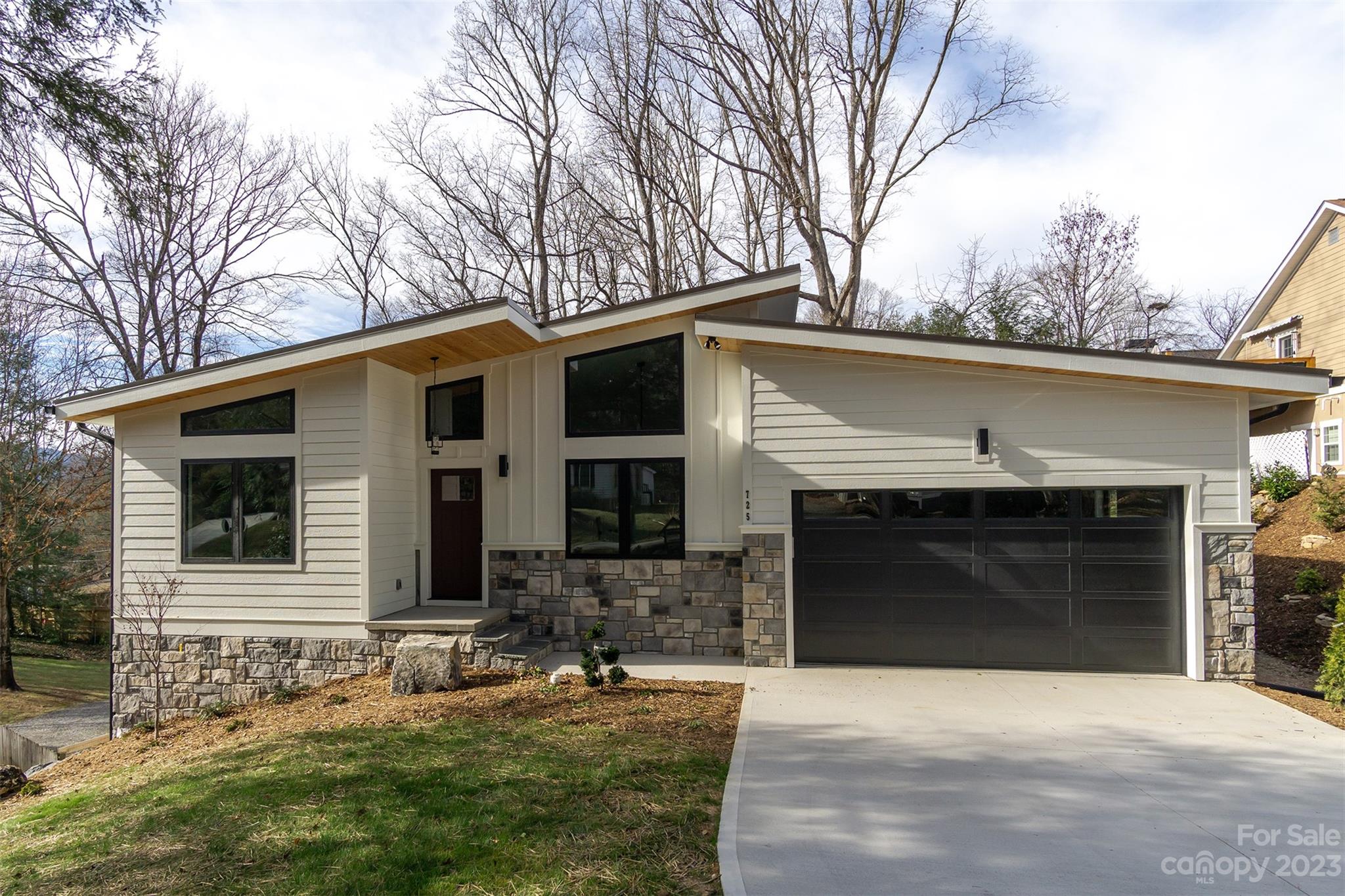 Welcome to 725 Rhododendron, a stunning example of contemporary elegance nestled in the heart of Black Mountain. This brand-new construction seamlessly blends modern design such as a striking facade that showcases clean lines, expansive windows, and a harmonious mix of materials. The thoughtful architecture maximizes natural light, creating a bright and airy atmosphere throughout the home. Enjoy single level living, open-concept layout, with gourmet kitchen featuring state-of-the-art appliances, sleek cabinetry, and a spacious island. The living area boasts a gas fireplace, while the dining area opens to a private outdoor space. 1415SF unfinished daylight basement can be expanded into 2BR, 1BA and a separate living space. Walking distance to Lake Tomahawk Park. Whether you're seeking a primary residence or a vacation retreat, this contemporary masterpiece invites you to experience a lifestyle where modern luxury meets the tranquility of the North Carolina mountains.