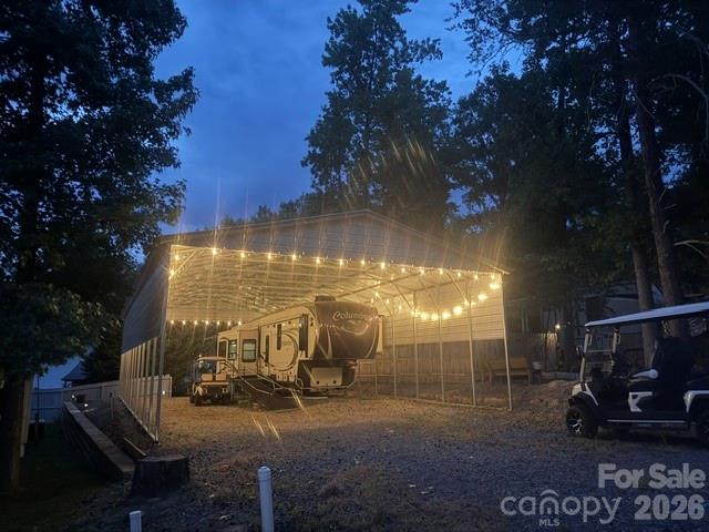 Great Listing 30X60 Metal Shed over 2013 Columbus 5th wheel fully furnished with appliances, large storage building, plumbed for washer & dryer, water heater in building.  Camera system installed for security, included in sale.  The lot has additional sq footage added to back part where building is.  Ramp will remain with the sale of the property but imagine how nice this would be with a patio or landing deck area covered under the shed.