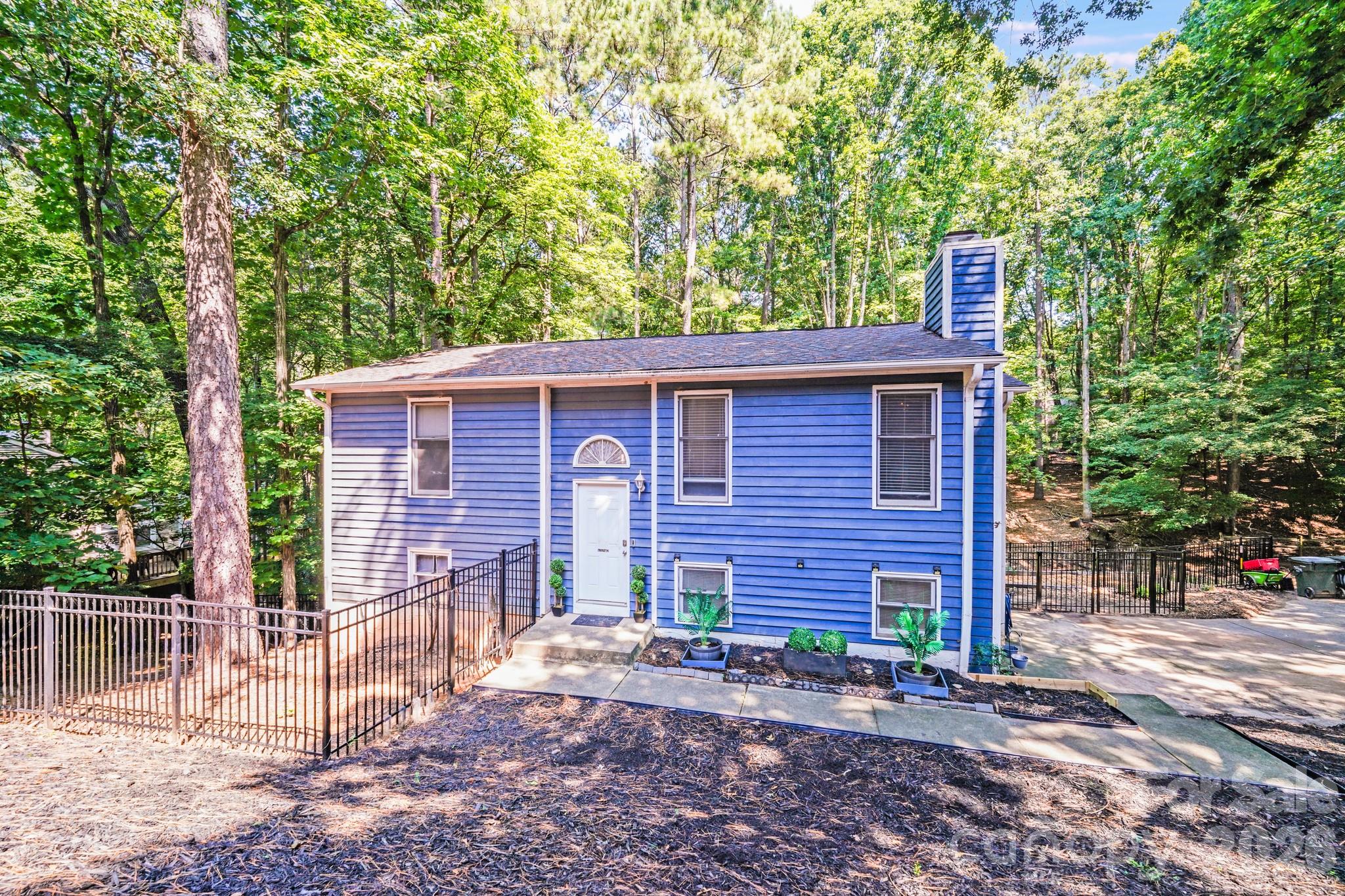 . *** Purchase in Confidence- Home has been inspected** In Tega Cay, this 4-bedroom, 2-bathroom split-foyer home offers functional living across two levels with a layout ideal for privacy and flexibility. The upper level includes two bedrooms, a full bath, a living room with a stone fireplace, and a kitchen with adjacent dining area that opens to the back deck.
The lower level features a second living space with built-in shelving, two additional bedrooms, another full bathroom, and access to the single-car garage where the laundry area is located.
Explore the private walkway with direct access to the lake, making it easy to enjoy water activities just steps from your door. The earth belongs to the City Parcel 6411001023.- the pier/dock belongs to a neighbor.
Residents enjoy a wide range of amenities including lake access, golf, parks, walking and biking trails, beach access, tennis courts, clubhouse, and a community pool.
Please Note: The driveway is shared and sloped. There is no formal documentation regarding maintenance responsibilities to the private driveway.
*This home may be eligible for up to 14 Down Payment assistance programs with potential buyer assistance up to $20,000. Contact your lender for programs and eligibility**