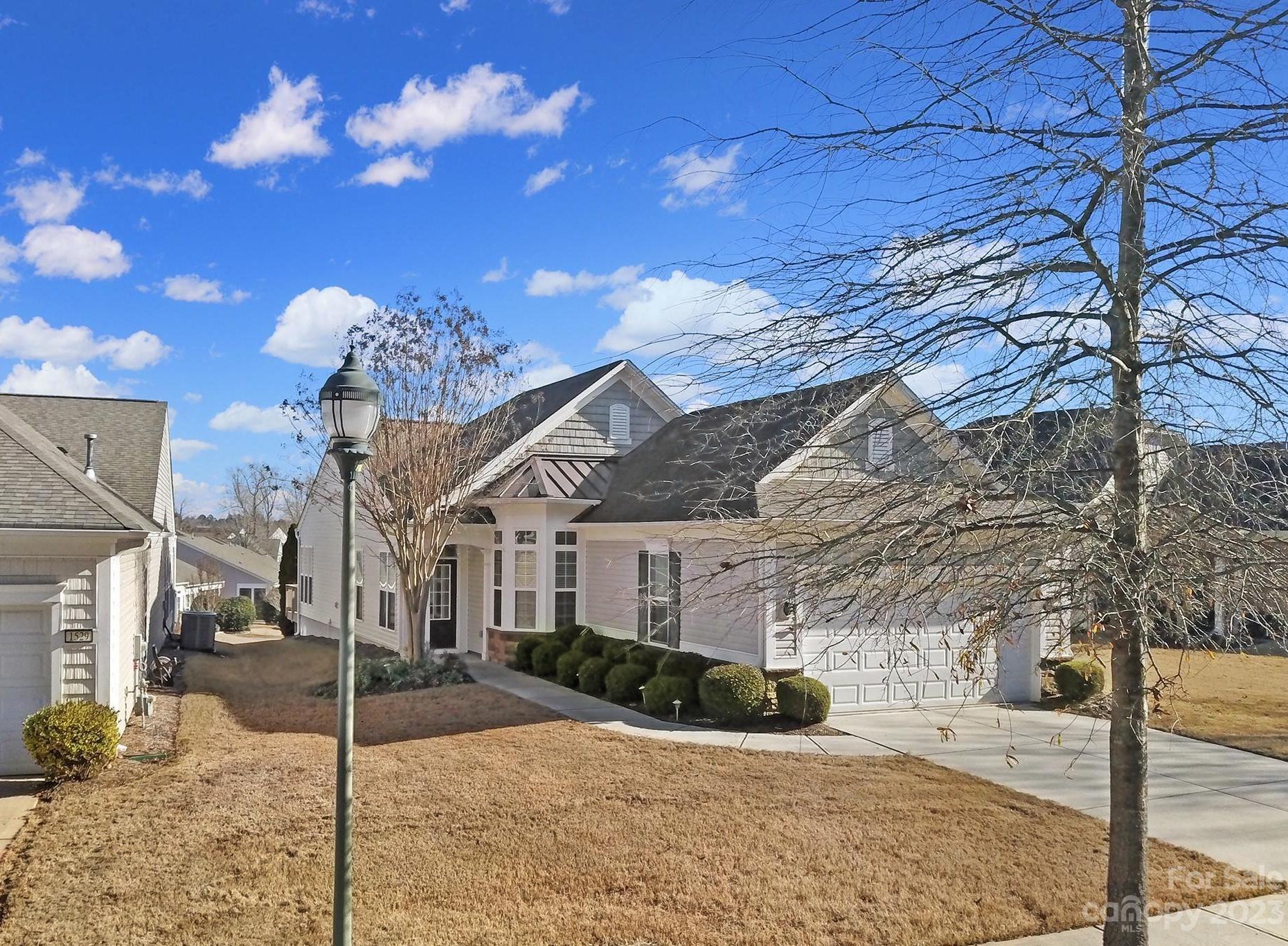 Move-in ready Gray Myst home in amenity-rich Sun City w/ neutral paint & pre-finished wood flooring in the main living areas & kitchen! Lots of natural light shines through the glass panel front door & transom window! The kitchen has SS appliances, tile backsplash, a desk area, & a sunny breakfast nook overlooking the front yard. Past the kitchen is the dining area & open great room, which flows into the bright & spacious sunroom. Get cozy, enjoy morning coffee, or read a book! Sliding glass doors open to the wooden deck, overlooking the privacy trees making this the perfect spot for relaxing! The primary suite is at the rear of the home & features an en-suite bathroom with a dual-sink vanity, glass shower, & walk-in closet! There are 2 additional bedrooms (one of which can be used as a home office or hobby room), with access to a full hallway bathroom. Don't miss your chance to join the active-adult lifestyle in Sun City and experience resort style amenities every day of the week!