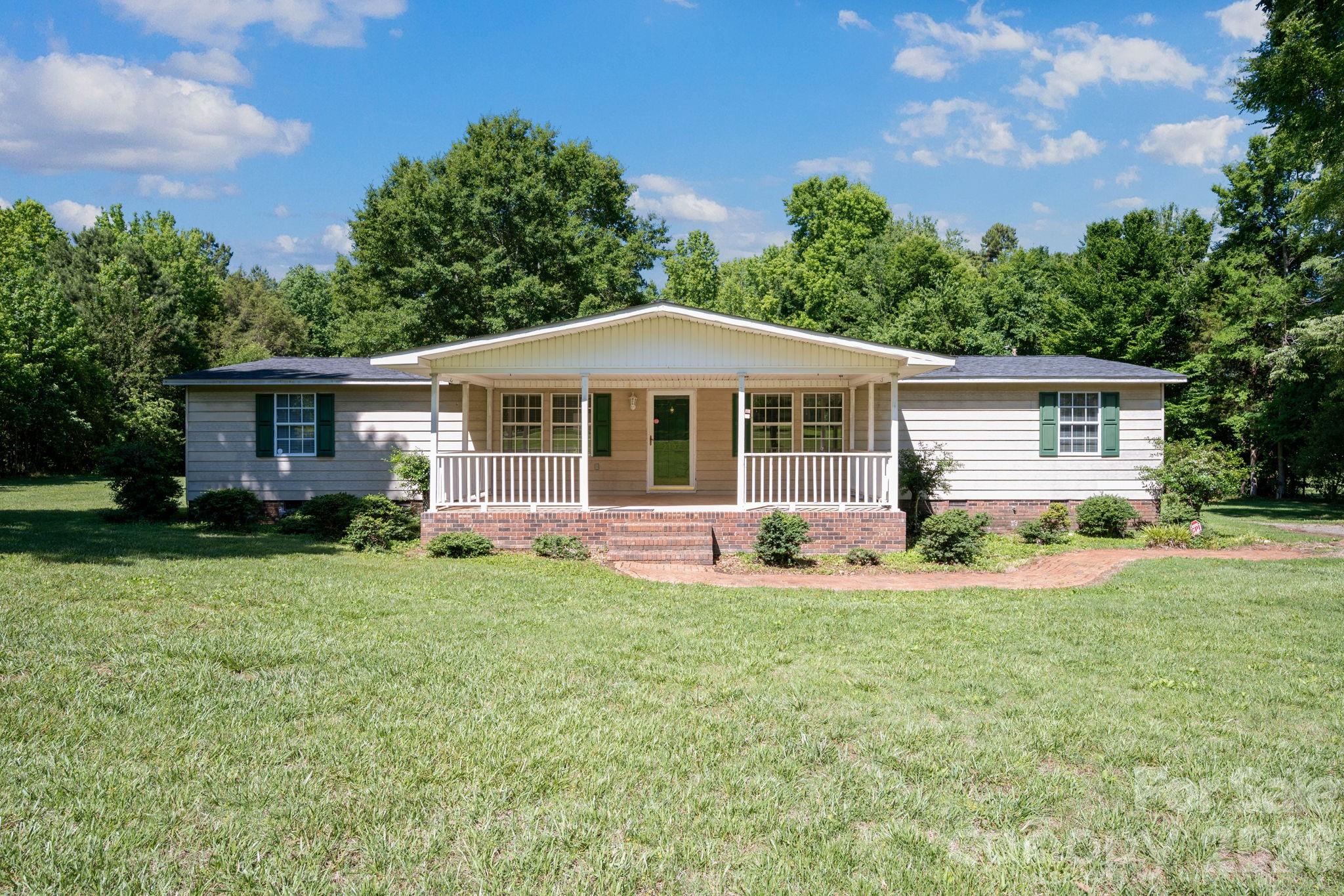 *Don’t miss your chance to own acreage in one of Lincoln County’s most sought-after areas! * 
 Whether you are looking for a home or an investment opportunity, this property offers endless potential in Denver North Carolina.  This lovingly cared for and well-maintained manufactured home boasts large added front and back porches that seamlessly expand the living spaces to the outdoors. Inside you will find the perfect combination of space, comfort and opportunity to make this 3 bedroom, 2 bath home your own. Hardwood floors, a sizeable laundry room and custom-built shelving in the large closets make this home a must-see!  The level yard has over 2 acres of usable space for work or recreation. This property is in the highly desirable North Lincoln School District. Located close to Highway 16 for easy access to Charlotte, Lincolnton and surrounding areas.