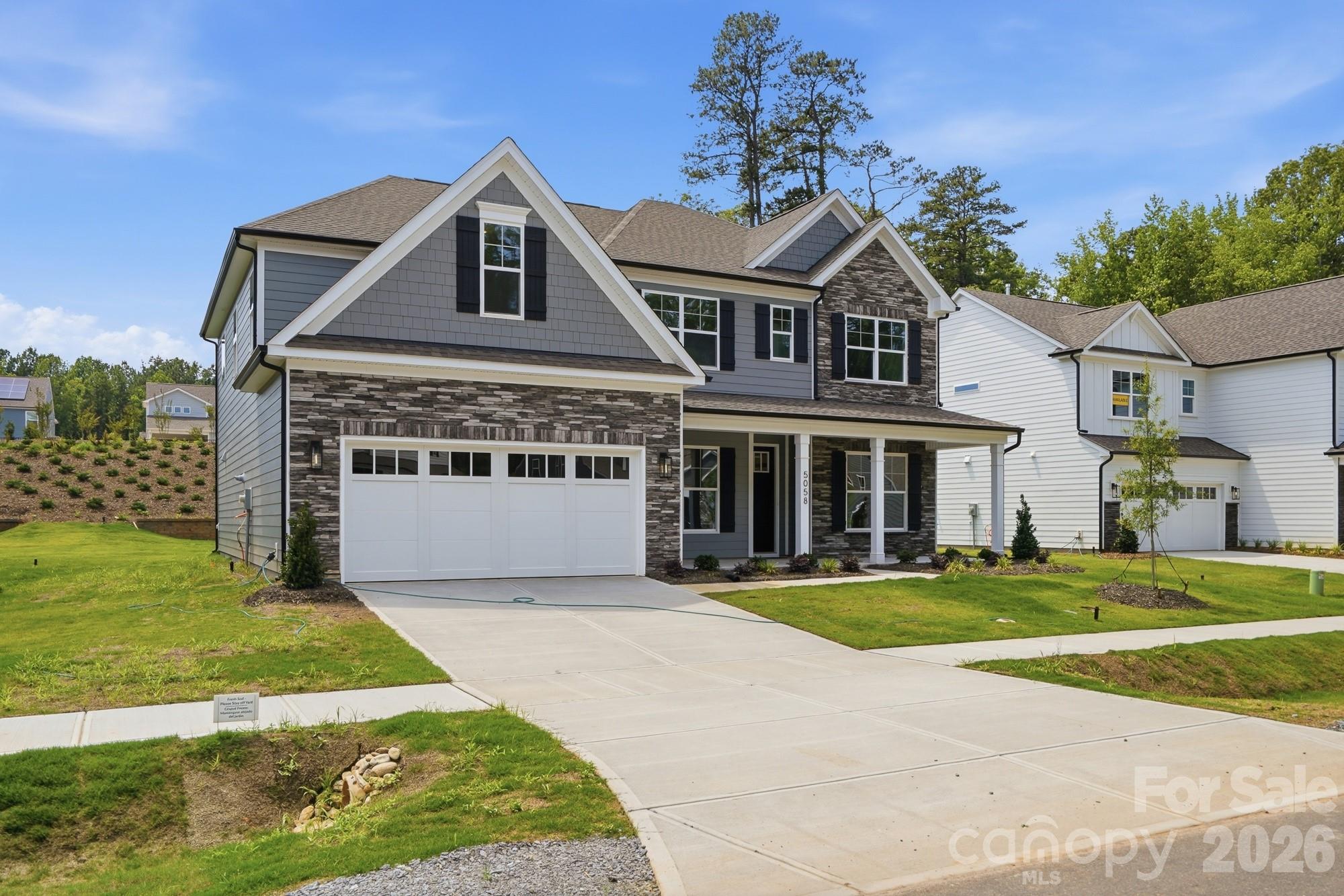This beautiful, 2-story Charleston plan offers almost 3,800 square feet of living space with 5 bedrooms and 4 full baths. The main floor includes a guest bedroom & full bath with 5-ft shower, a large kitchen with white cabinets and a contrasting gray island, butler pantry with upper & lower cabinets, family room with a Cosmo gas fireplace & shiplap accent wall, a dining room with tray ceiling, and an office with French doors. The kitchen also features a farmhouse sink, a stainless range hood, and stainless appliances, including a gas cooktop. The second floor includes a large bonus room with two closets, the primary suite with a luxury bath that includes a free-standing tub, three secondary bedrooms, a hall bath, and a Jack-n-Jill bath. Other wonderful upgrades include a rear covered porch, foyer with tray ceiling, beadboard drop zone in the mud room, laundry room with cabinets, tankless water heater, and stairs with composite treads & metal balusters. Visit today and find out more!