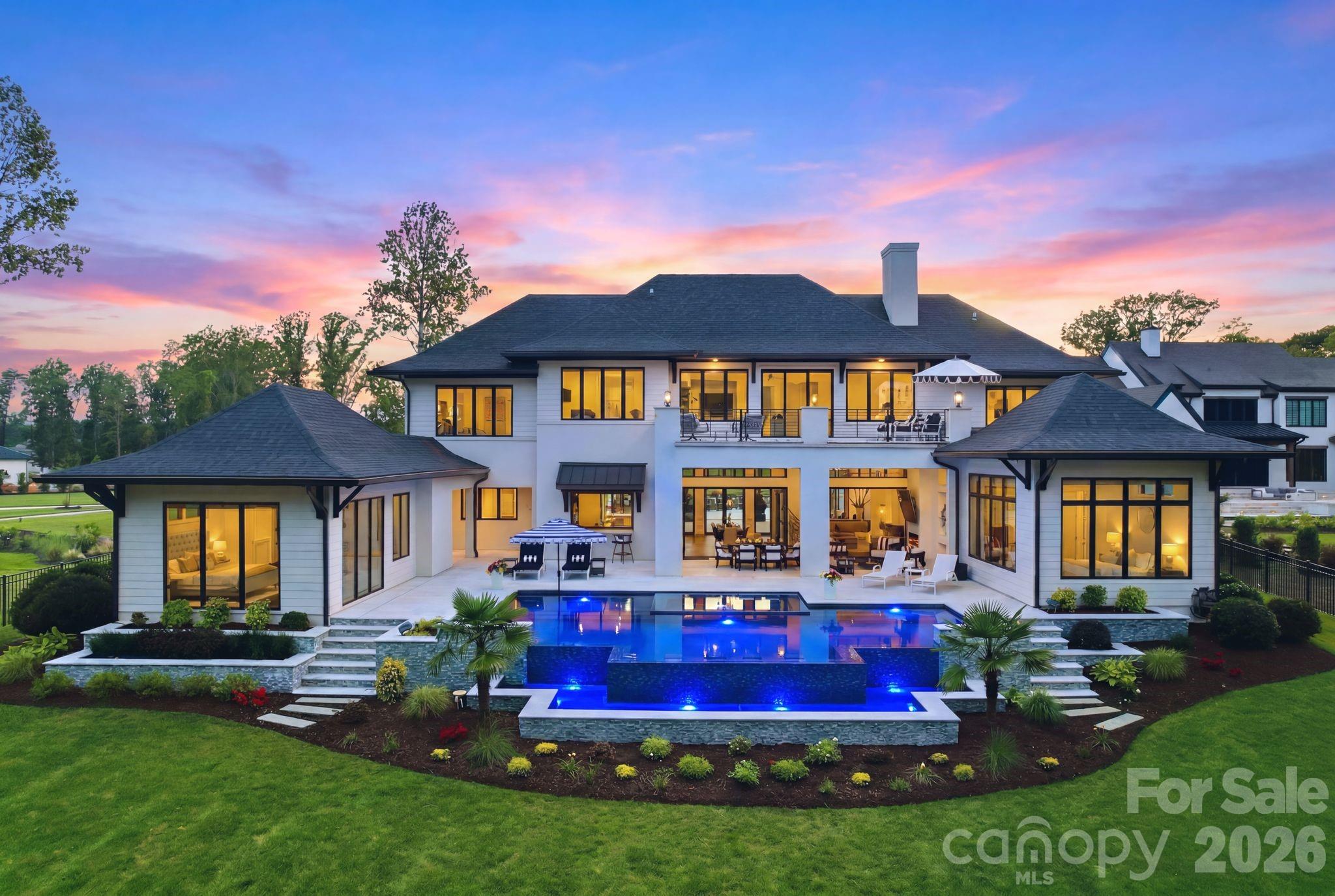 Designed for those who expect the exceptional, this modern waterfront estate redefines luxury living on Lake Norman. Positioned on 1.12 acres with approximately 156 feet of shoreline within the exclusive Saylors Watch community, the residence seamlessly blends sophisticated architecture, cutting-edge technology, and resort-inspired amenities.

Built by Southern Cottage in 2022, this stunning custom home was recently refreshed with newly refinished hardwoods and fresh interior paint. The home showcases breathtaking year-round lake views from nearly every room, highlighted by soaring ceilings and expansive walls of glass. Additional luxury features include an elevator, Lutron motorized shades, and Control4 smart-home technology, which seamlessly manages lighting, shades, audio, climate, security, and pool functions throughout. The chef’s kitchen is appointed with premium Thermador appliances, separate refrigerator and freezer, ice maker, oversized island, and a fully equipped scullery with built-in espresso machine, refrigerator, and dishwasher—designed for effortless entertaining.

A dramatic three-sided DaVinci fireplace anchors the great room and dining area, which open through Andersen accordion doors to an extraordinary outdoor living experience featuring a covered, screened veranda with fireplace, mounted heaters, and dedicated lounge and dining areas. An expansive marble terrace surrounds the infinity-edge pool, oversized spa, fire features, immersive landscape audio, and multiple gathering spaces overlooking the water. Designed for effortless entertaining, the space also features a bar pass-through from the kitchen and a separate outdoor kitchen.

The owner’s suite offers a spa-inspired bath complete with steam shower, bubble massage soaking tub, heated bidet, and integrated mirror TV. A private detached casita with kitchenette offers exceptional flexibility for guests, a private office, executive retreat, or extended-stay accommodations. Upstairs, an expansive billiards and media room with wet bar opens to a large second-level waterfront terrace, creating an ideal setting for entertaining or taking in the panoramic lake views.

A private custom stationary dock with 12,000-pound boat lift, dual finger piers, and dedicated jet ski pier provides direct access to Lake Norman for boating and waterfront recreation. The heated and cooled single-car garage includes a full-size wash station ideal for pets or lake gear. Beautifully landscaped grounds include a fenced dog run. Offering an unmatched combination of craftsmanship, luxury, and waterfront lifestyle, this is a rare opportunity to own one of Lake Norman’s premier custom estates.