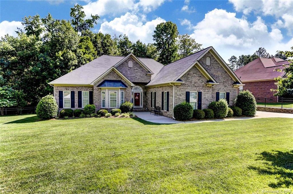 Beautifully designed and built contemporary brick home with 2 car side load garage, beautifully landscaped, wired brick building in rear.  Extra design touches make this home a must see.  Large rooms, soaring ceilings, trey ceilings, rear deck for privacy.  Fireplace in great room, breakfast bar. Open floor plan, split bedroom plan.  Master with door to small side porch for relaxing with coffee in AM.