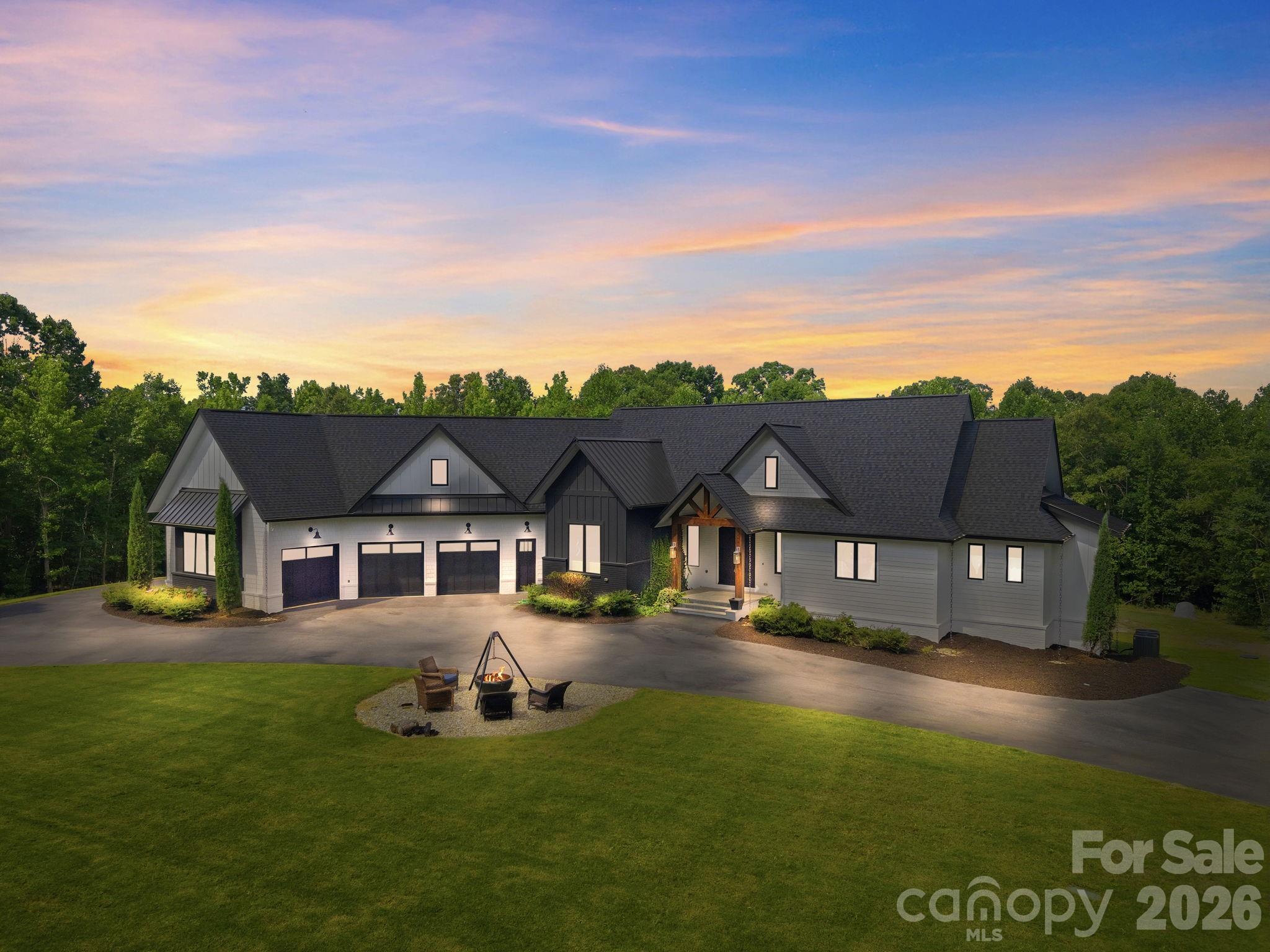 ELEGANT custom-built ESTATE w/exceptional attention to detail! McNeely Farms is an upscale, equestrian-friendly community featuring large custom homes on 3 to 5+ acre lots. Located near Mineral Springs, this neighborhood offers a tranquil setting w/wooded terrain and access to the local greenway directly across from the neighborhoods main entrance. Nestled in the back left corner of the neighborhood, this private sanctuary sits on 3+ acres & also features a charming 2-bedroom guest cottage which provides plenty of room inside & out for family & guests. The main home presents with an expansive circular driveway & 4-car garage providing abundant parking. Be prepared to be impressed as you approach the front entrance! You are welcomed by substantial custom double metal doors giving a taste of what to expect next!

Inside, you will be captivated by the home’s remarkable architectural details, including antique brick from the 1880's gracing the fireplace, intricate ceiling ornamentation, beautiful wide-plank hardwood floors, imported tile, & so much more.

Enjoy seamless indoor-outdoor living w/a serene covered terrace featuring TREX flooring, wiring for speakers & television, accordion sliding doors opening from the main living area invite in the surrounding natural beauty.

The chef’s kitchen is truly exceptional, featuring top-of-the-line Wolf appliances including double wall ovens w/ convection cooking & thermometer probe, gas cooktop, refrigerator drawers, & a built-in Sub-Zero freezer. Additional highlights include beautiful custom cabinetry (some w/unique rain glass fronts), a hidden appliance cabinet, pantry w/motion-sensor lighting & space for two refrigerators or freezers, dual garbage pullouts. Expansive center island w/stunning walnut countertop and an oversized custom extended galley sink with dual faucets and reverse osmosis tap. Kitchen also features an additional standard size galley sink. The fireplace adds the perfect finishing touch.

The luxurious main-level Primary Suite features his-and-her closets. The custom-designed "her" primary closet includes built-in shelving & drawers, pull-out necklace trees, upper third-row pull-down rods w/soft-close functionality for easy access. The spa-inspired bath offers a large deep soaking copper tub, leather-finished granite countertops, custom cabinetry & an amazing walk-through shower w/built-in speakers. Additional features include wiring for a TV in front of the tub, specialty tile, outlets inside cabinets for convenient and discret charging stations & a free form custom vanity.

Additional highlights include:
• Area designated for a future elevator
• Drop zone with hooks crafted from antique railroad ties
• Entire home wired for surround sound and security system including cameras
• Marine-grade outdoor water connections
• Well with NEW pump, NEW motherboard, filtration system, and water softening system
• Revani water system in the primary bath
• Central vacuum systems in the primary bath, kitchen, laundry room, and bar area, each with 21 feet of range

The lower level features a spacious family room, game area, space designated for a safe room (also ideal for a wine room), expansive gym with custom rubber flooring, media room, bar, playroom (wired for a golf simulator), three bedrooms & two full baths with custom tile—one featuring tile imported from Italy & the other from Spain—plus a storage/mechanical closet.

••Closet near the garage entry can easily be reconfigured to a staircase leading to the MASSIVE unfinished attic, offering the opportunity to expand the finished living area or provide exceptional additional storage.

For Horse lovers, McNeely Farms Equestrian Center is a stones throw away & offers full service horse boarding & dressage training facility. This property truly HAS IT ALL! Meticulously built and beautifully maintained, this ONE-OF-A-KIND ESTATE offers luxury, privacy & exceptional craftsmanship throughout.
