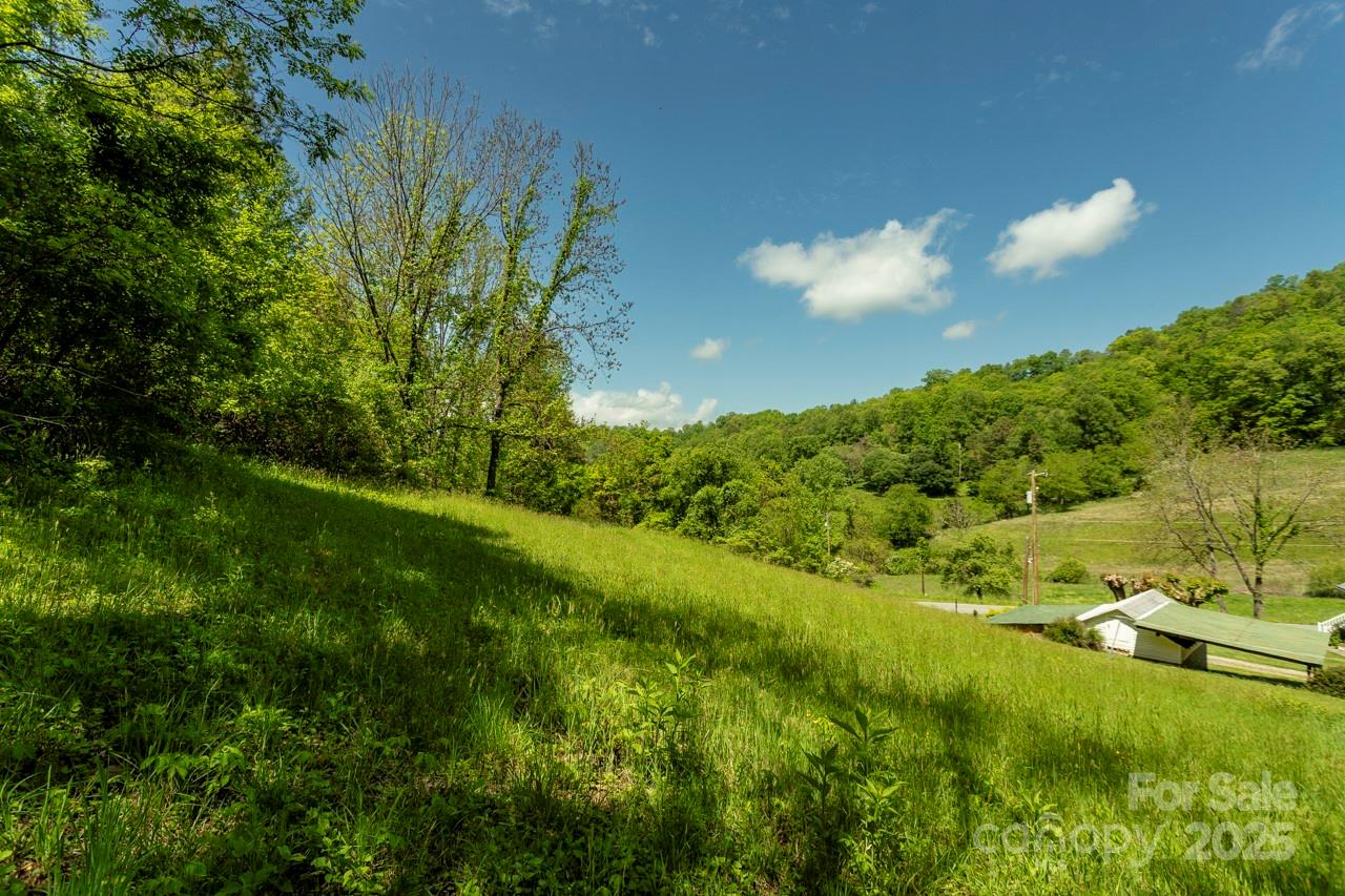 Don’t miss this incredible opportunity to own 21 unrestricted acres just minutes from Western Carolina University and Sylva. With paved state road access, no HOA, and no city taxes, this property offers the perfect blend of convenience, privacy, and freedom.

A stunning mix of cleared pasture and mature hardwoods provides a picturesque setting ideal for a private residence, second home, or mini-farm. Enjoy breathtaking mountain views, gentle rolling terrain, and multiple potential building sites. Whether you're dreaming of gardening, raising cattle or horses, or simply escaping to your own peaceful retreat, this land offers it all.

Opportunities like this are truly rare this close to all amenities but a feel of private seclusion. Come see the beauty and potential of this exceptional property for yourself—truly gorgeous land ready for your vision!

Must have appointment scheduled through Showing Service to be on property.  Follow showing instruction please.