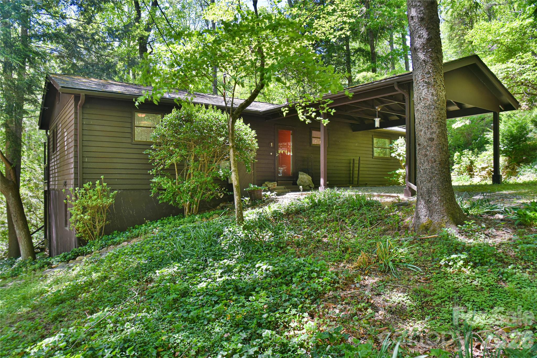 CHARMELDEE ACRES!!!
Yes...Privacy, tranquility and proximity to town still exist in Black Mountain.  1 Hillcrest Lane is a cottage/bungalow style retreat.  You can feel the love as you come through the front door.  This oasis features Mid-Century design and finishes...a sunken living room, vaulted ceiling with exposed beams, open air living spaces.  Cultivate an indoor garden in a converted firewood box. Unique!!!  The .80 acre lot offers trails and meditation spots with native fauna and flora.
Come and visit, then make it your own.
Better Hurry!