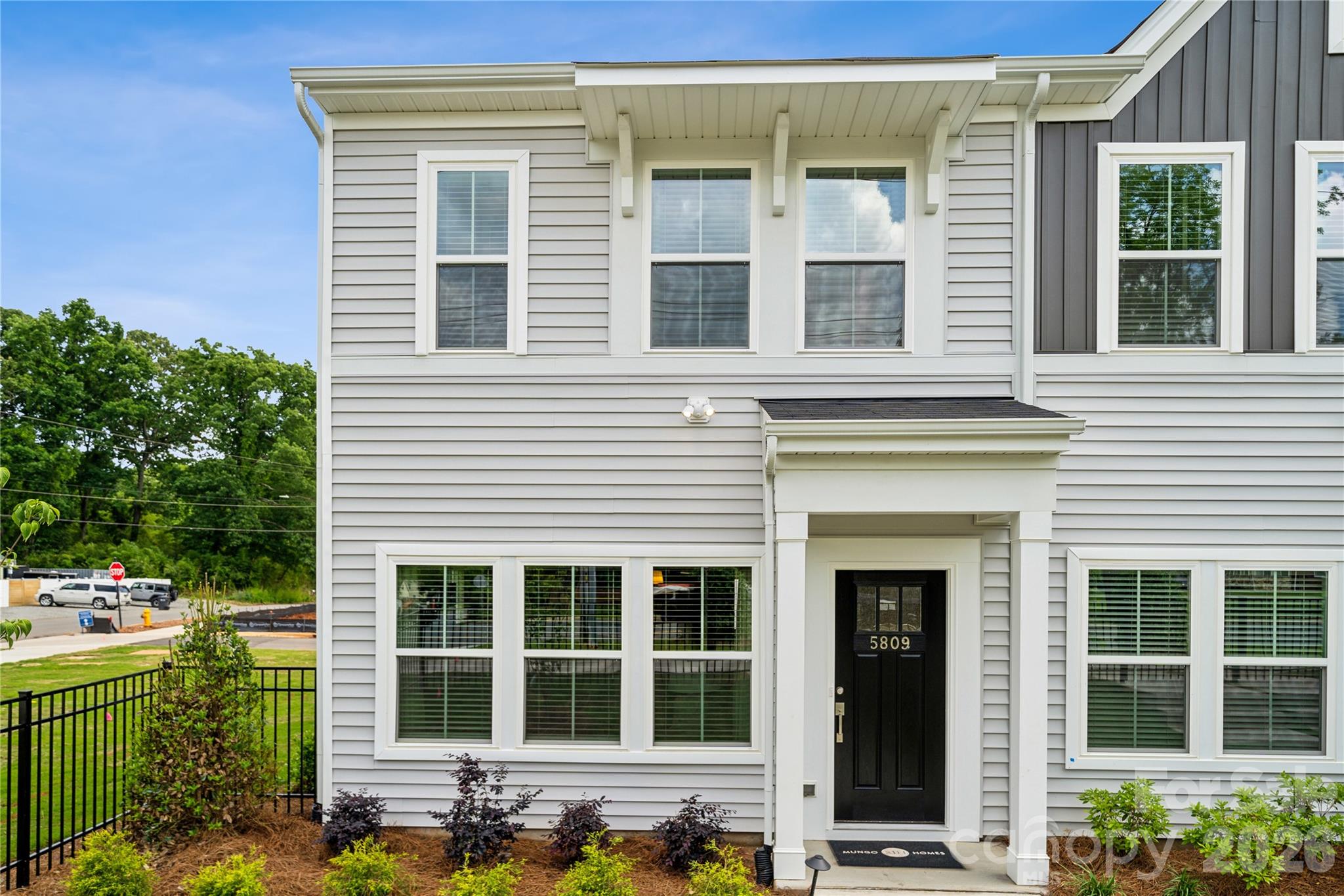 Welcome to this beautifully designed end-unit two-story townhome—ideal for first-time homebuyers looking for comfort, style, and smart use of space. With three bedrooms, two-and-a-half bathrooms, and extra natural light from additional windows, this home offers the perfect blend of function and charm. Step inside to a bright, open-concept layout where the great room flows seamlessly into the kitchen and eat-in dining area—perfect for hosting friends or relaxing at home. The thoughtful design makes everyday living feel easy and connected. Upstairs, the private primary suite features a spacious walk-in closet, a boxed ceiling for added character, and a dual-sink vanity—providing a peaceful retreat after a long day. Two additional bedrooms, a full bathroom, and a conveniently located laundry closet complete the second level, offering everything you need in just the right amount of space. From the attached one-car garage, you’ll find a welcoming entry with a built-in bench and cubby to help keep everyday essentials organized. A main-level powder room adds convenience for you and your guests. As an end-unit, this home offers more privacy, extra windows for natural light, and added quiet—features you’ll love as you settle into your first home.