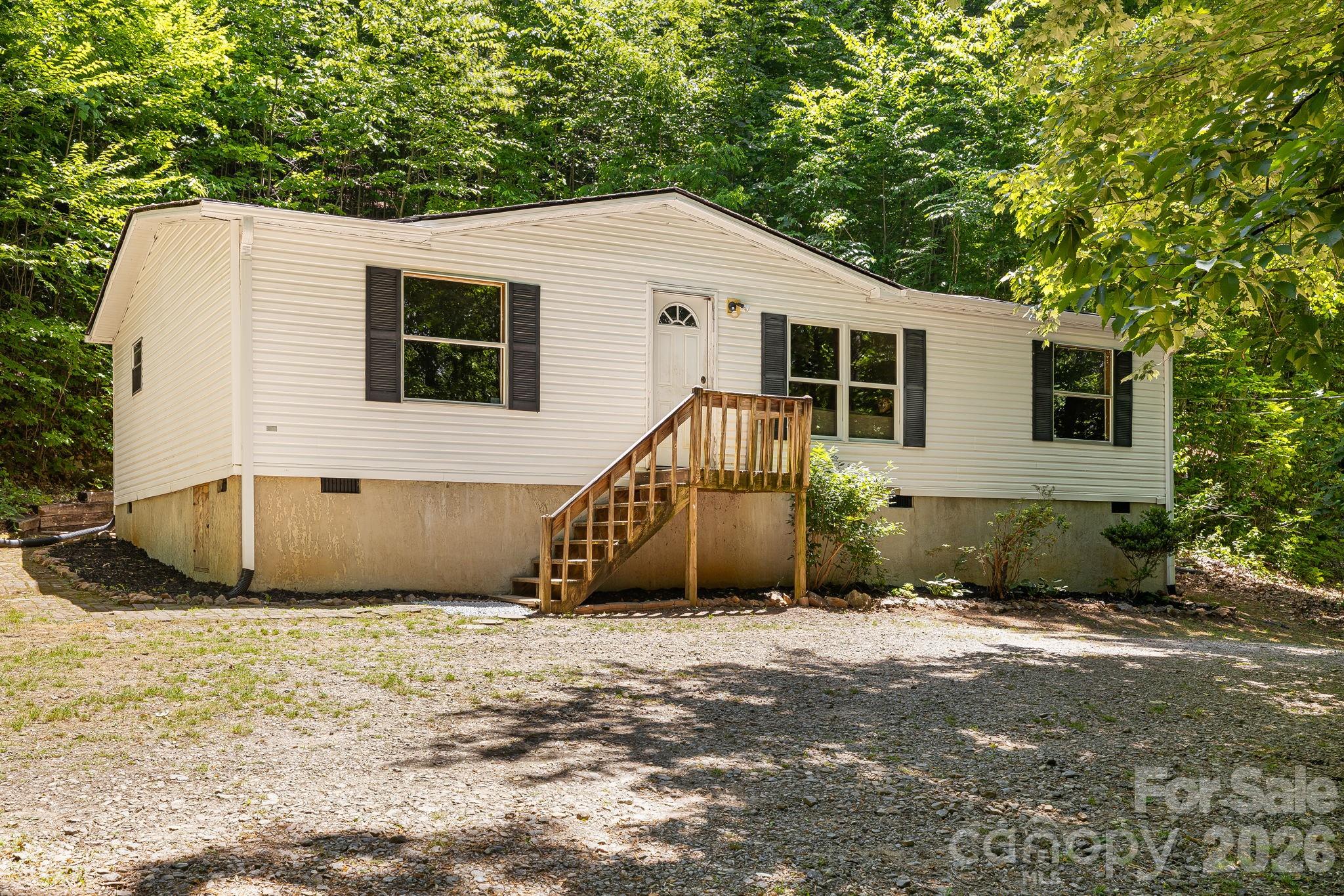 Come home to Candler!  This three-bedroom, two-bath home is ready to move in and make it your own.  Privacy and trees are in abundance on 2.60 acres.  There is plenty of room for your hobbies with two storage units/sheds.  Hike above your property to your private deer stand! Entertain friends and family with plenty of parking and room to grill and chill on your expansive back deck. Schedule a showing today to discover the value and possibilities that await you at 94 Long Ridge Road!