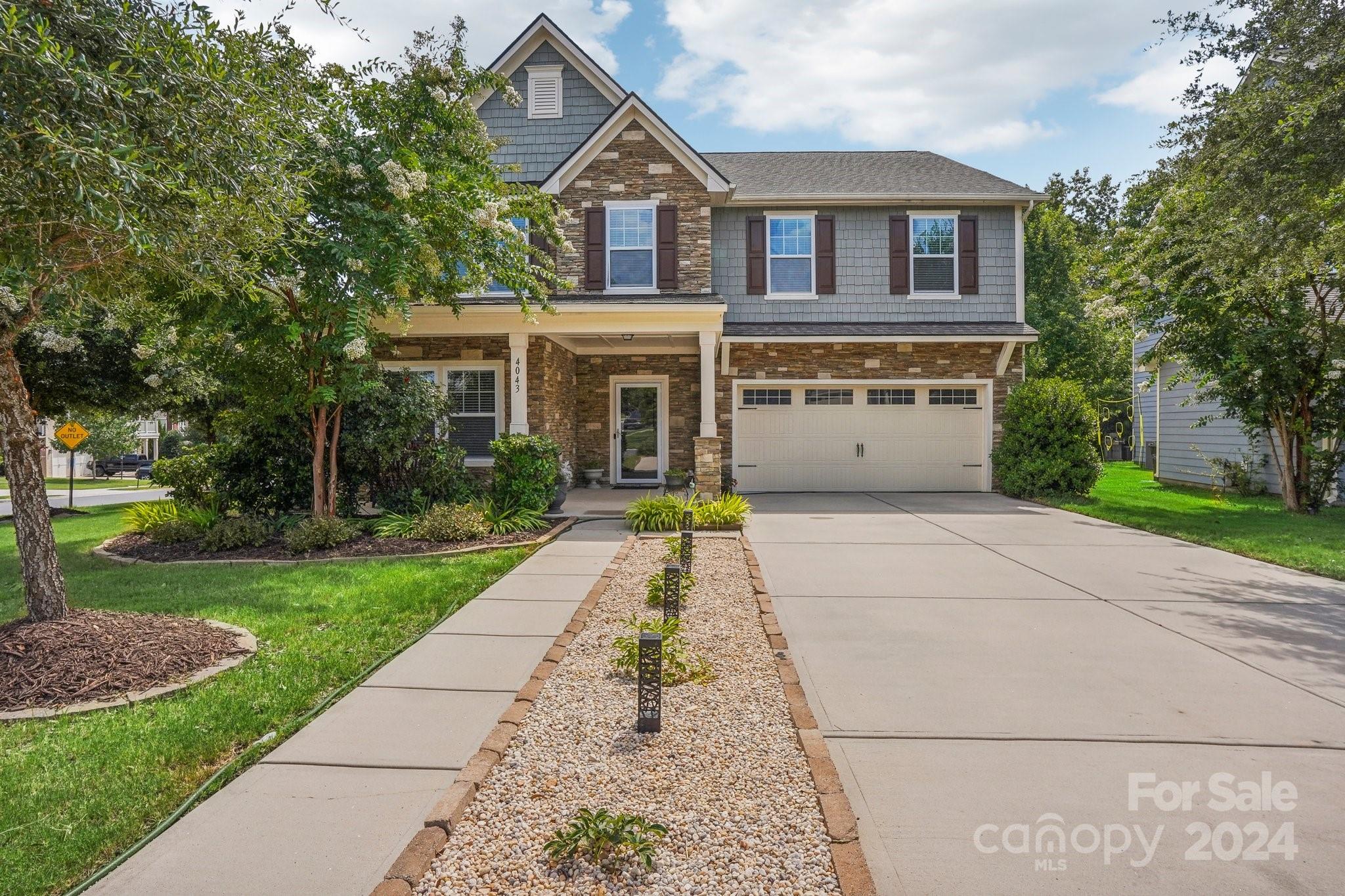 Discover this charming 5-bedroom, 3.5-bathroom home nestled in Lake Ridge neighborhood. Freshly painted & featuring modern upgrades. 

The main level boasts an en suite bedroom, perfect for guests or multigenerational living. The living room is pre-wired for surround sound, enhancing the entertainment experience. The gourmet kitchen shines with a beautiful island, ideal for meal preparation and casual dining.

Upstairs, four additional bedrooms provide ample space for family and guests, along with a versatile bonus room offering endless possibilities. The garage includes a Tesla wall mount charger for added convenience.

Lake Ridge amenities, including an Olympic-sized pool with a slide, tennis & basketball courts, playgrounds, walking trails, clubhouse, & a gym. Located within the excellent Tega Cay school district, this neighborhood is perfect for families seeking top-rated educational opportunities.
