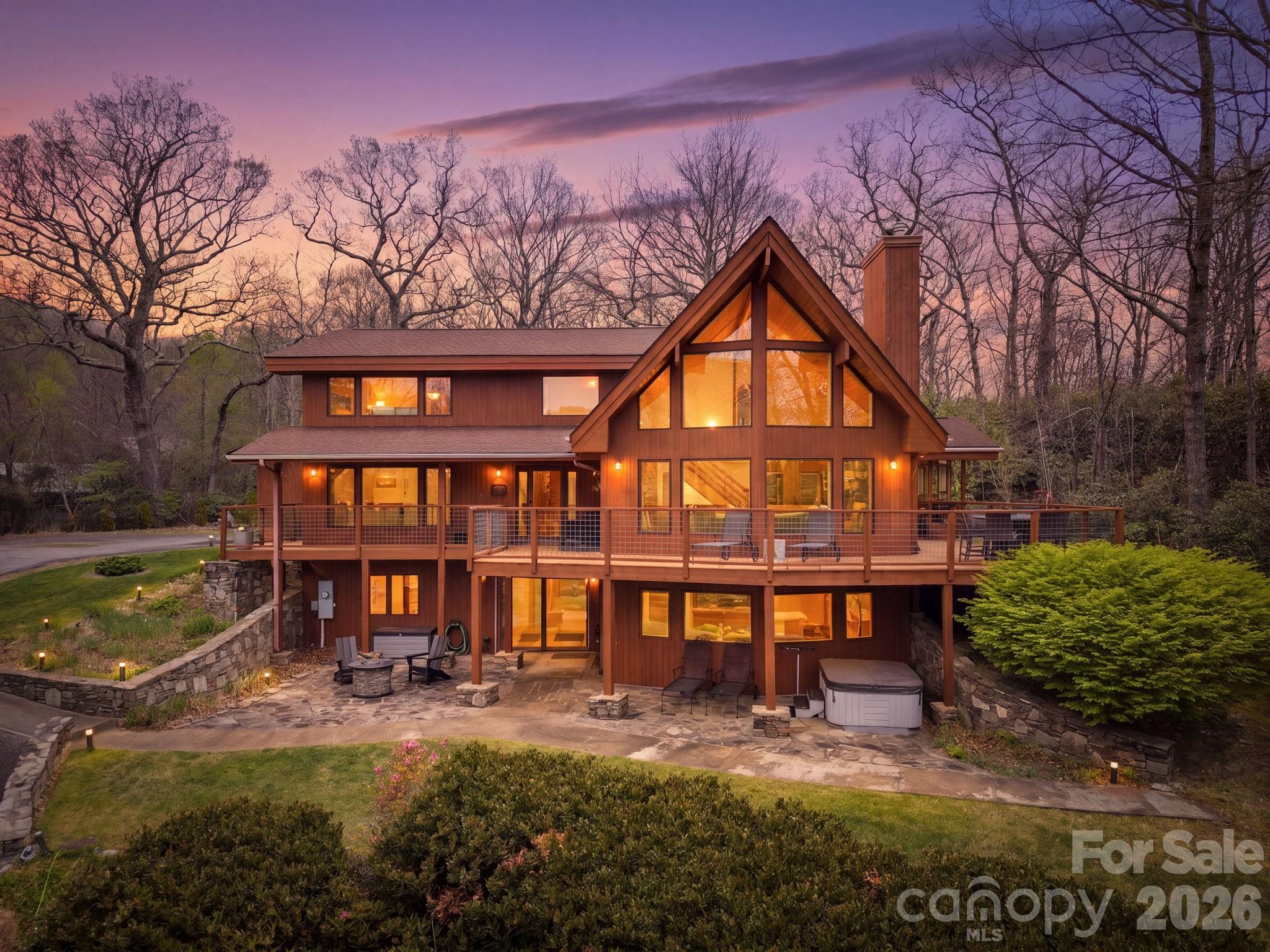 Book your showing today for this stunning mountain home in the prestigious gated community of Laurel Ridge. Surrounded by 17,000 acres of protected forest, Laurel Ridge is quietly positioned in the unspoiled North Fork Valley of the Blue Ridge Mountains. Step inside this 3500 square foot home and settle into mountain time. On the main floor you’ll fall in love with the soaring cathedral ceilings and window wall. Paired with the grand stone fireplace and mountain views, this is the perfect place to experience the seasons. Also on the main floor you’ll find a half bathroom, executive office, dining room, and the kitchen which features leathered stone countertops and premium finishes. On the top floor, the primary suite features a beautifully remodeled ensuite bathroom, along with two additional bedrooms and a second updated bathroom. The upstairs is completed with a loft-style sitting area that overlooks the living room and showcases beautiful mountain views. The lower level delivers exceptional flexibility offering a private suite complete with its own kitchen, living room, bedroom, full and half bathrooms, and a cozy wood stove. With exterior access and dedicated patio, it offers ideal separation for elevated guest accommodations, multi-generational living, or a lucrative short term rental. Short term rentals are allowed!! Step outside and enjoy the peace and quiet that defines the setting. The spacious wrap around deck invites effortless indoor-outdoor living with a covered section to enjoy any season. The large garage offers ample space for vehicles, toys, workshop, or whatever you please. Don't miss this special mountain retreat! Note: Home has five bedrooms, but the septic permit is for three. Fantastic location only 15 mins to downtown Black Mountain and 30 mins to downtown Asheville. Seller financing available! Call listing agent for details.
