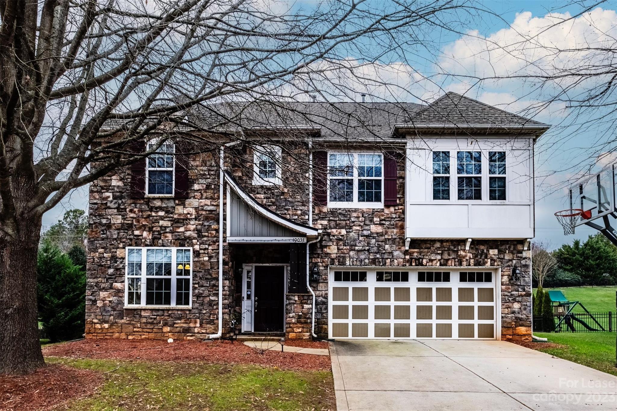 "Welcome home to your beautiful Ballantyne gem, available for you today! Nestled in a picturesque neighborhood with prime location, this lovely home boasts a main-level bedroom—perfect timing to make it yours for The NEW YEAR! With four additional bedrooms upstairs and a spacious loft, there's ample room for the whole family to stretch out.

Step outside to a sizable yard featuring a patio and an enclosed sunroom, creating seamless indoor-outdoor living (landscaping covered by owner). Inside, a generous eat-in kitchen and a snug, freshly painted, family room complete with a fireplace, make this space the ultimate cozy retreat for family gatherings or busy days on the move.

Enjoy the comfort of new carpet throughout and gleaming hardwoods on the main level. Don't let this chance slip by to be in proximity to top-notch schools and relish all the fantastic amenities this neighborhood offers!