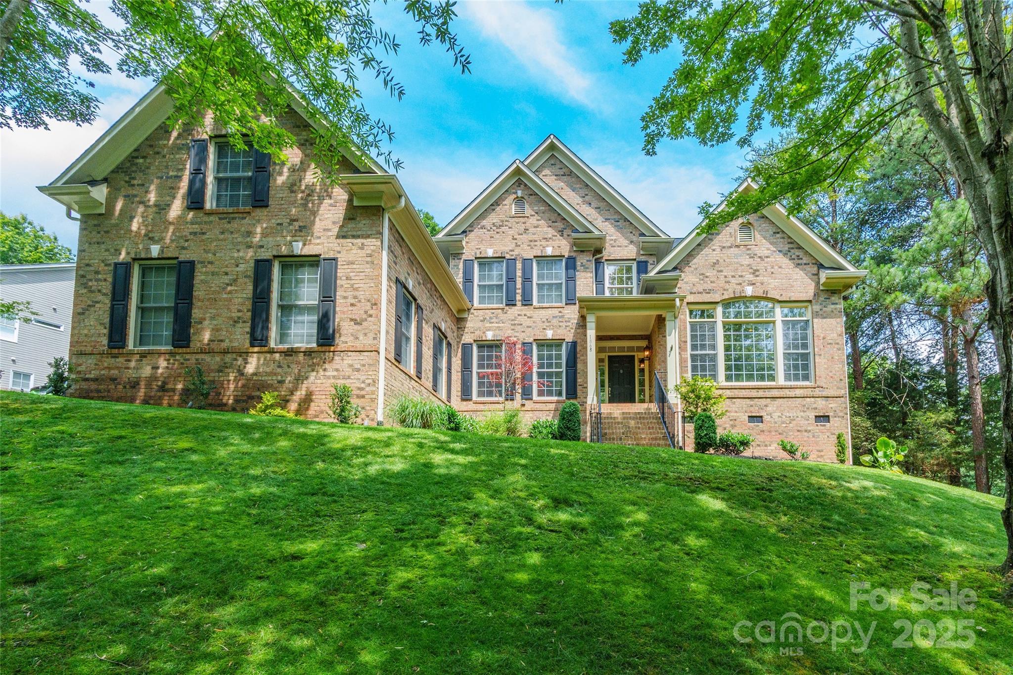 This is the Home that dreams are made of!! Step inside this stunning, custom home to beautifully hand-scraped hardwood floors that flow throughout the main level. The foyer opens to a breathtaking two-story family room, where soaring ceilings and a wall of windows bathe the interior in natural light and frame the surrounding greenery like artwork. At the heart of the home lies a show-stopping kitchen featuring a massive waterfall island ideal for gathering, cooking, and entertaining. Sleek finishes, high-end appliances, and custom cabinetry elevate the space. Oversized rooms throughout the home provide comfort and flexibility, including a luxurious primary suite on the main level. Step outside to your own private resort: a sparkling pool with travertine decking, relaxing hot tub, cozy fire pit all in a backyard oasis offering the perfect backdrop for gatherings or peaceful solitude. Located in highly desirable Tega Cay, in an amenity rich neighborhood, this home has it all!!