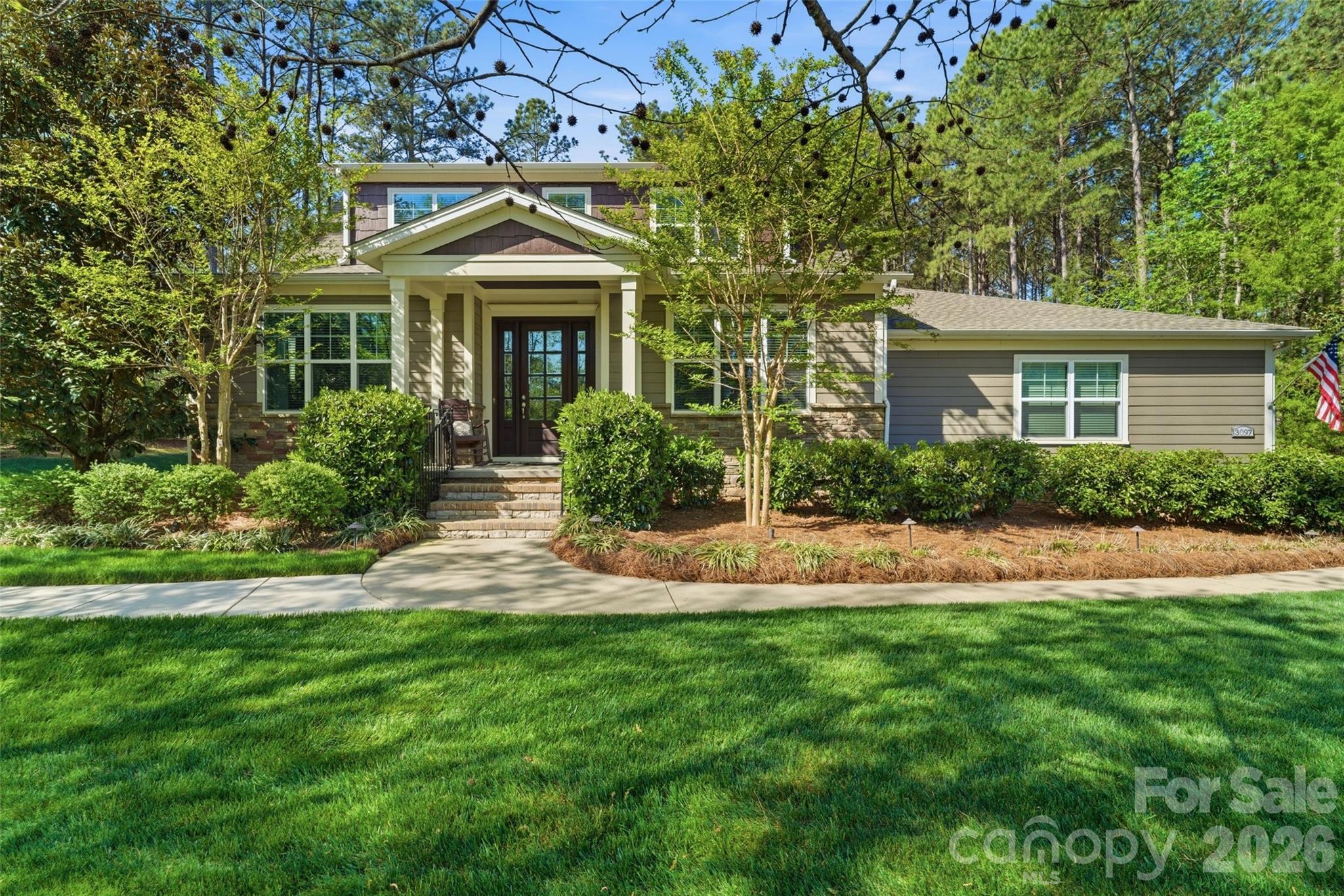 If you’ve been waiting for privacy, views, and convenience all in one—this is it. Located in desirable Riverchase Estates, this Craftsman-style home is surrounded by peaceful woods, offering stunning views from every level. Natural light pours in through expansive windows, highlighting beautiful details like tray ceilings, designer lighting, and custom built-ins. Enjoy the feeling of a secluded retreat while staying just minutes from Ballantyne, Indian Land, and major commuter routes. A dedicated office provides the ideal work-from-home space. The gourmet kitchen is a true standout, featuring top-of-the-line stainless steel appliances, a large center island, gas range, and a pantry with custom shelving and lighting, all seamlessly connected to a functional open floor plan ideal for everyday living and entertaining. The main-level primary suite provides comfort and privacy, creating a true retreat within the home. Stacking sliding doors open to a covered back porch with a fireplace and outdoor kitchen, creating exceptional indoor-outdoor living. An extended paver patio offers additional space to relax or entertain while enjoying the serene backdrop, and a backyard storage shed adds convenience. A fully finished 2-car garage features upgraded rubberized flooring for a clean, modern look. A new roof was installed in 2025. Residents of Riverchase Estates enjoy exceptional amenities including a gated entrance, clubhouse, outdoor pool, tennis courts and more. Ideally located, this home offers the perfect balance of tranquility and accessibility, just minutes from Ballantyne, Indian Land, and interstate access. Schedule a showing today!