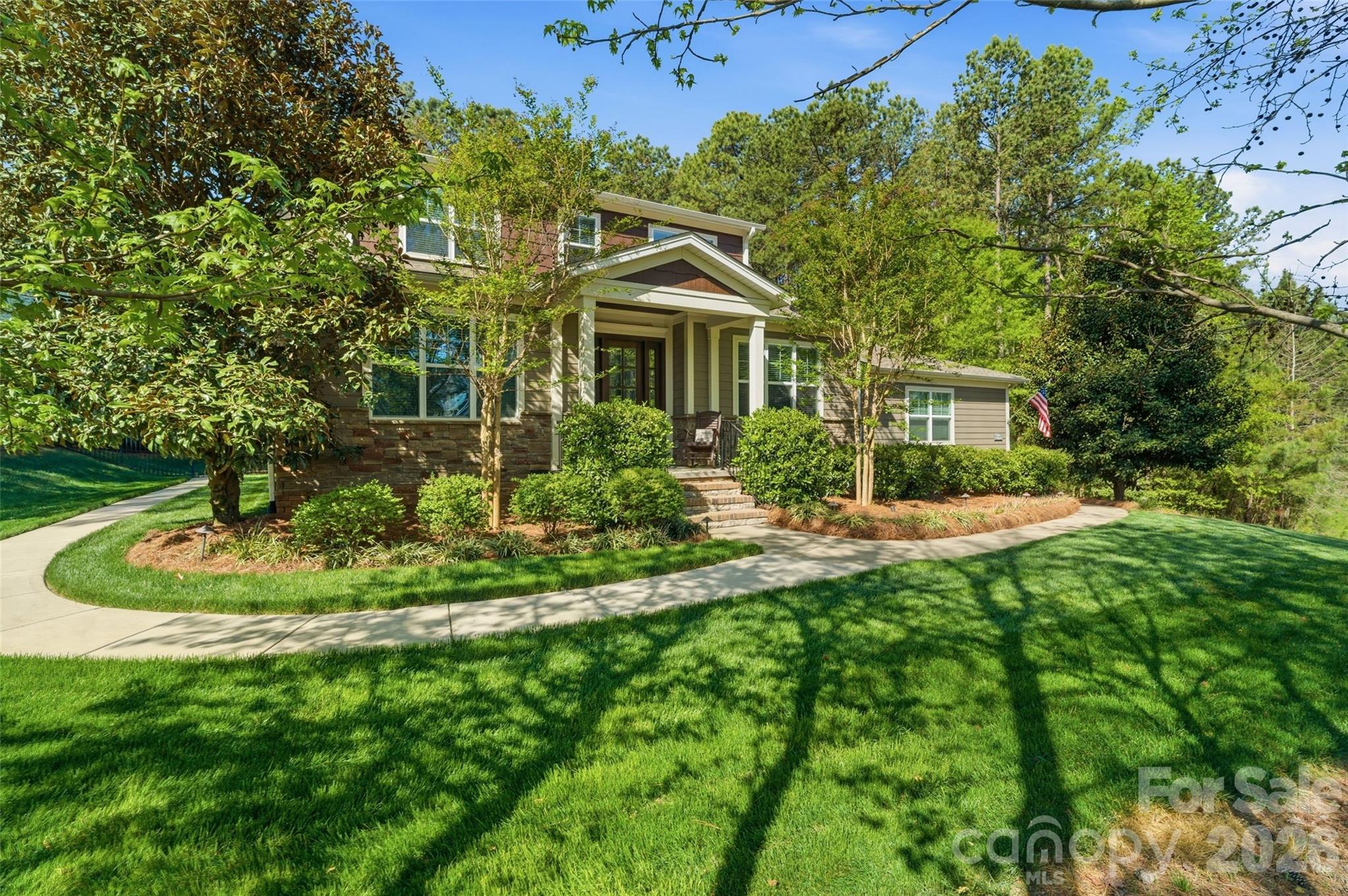 If you’ve been waiting for privacy, views, and convenience all in one—this is it. Located in desirable Riverchase Estates, this Craftsman-style home is surrounded by peaceful woods, offering stunning views from every level. Natural light pours in through expansive windows, highlighting beautiful details like tray ceilings, designer lighting, and custom built-ins. Enjoy the feeling of a secluded retreat while staying just minutes from Ballantyne, Indian Land, and major commuter routes. A dedicated office provides the ideal work-from-home space. The gourmet kitchen is a true standout, featuring top-of-the-line stainless steel appliances, a large center island, gas range, and a pantry with custom shelving and lighting, all seamlessly connected to a functional open floor plan ideal for everyday living and entertaining. The main-level primary suite provides comfort and privacy, creating a true retreat within the home. Stacking sliding doors open to a covered back porch with a fireplace and outdoor kitchen, creating exceptional indoor-outdoor living. An extended paver patio offers additional space to relax or entertain while enjoying the serene backdrop, and a backyard storage shed adds convenience. A fully finished 2-car garage features upgraded rubberized flooring for a clean, modern look. A new roof was installed in 2025. Residents of Riverchase Estates enjoy exceptional amenities including a gated entrance, clubhouse, outdoor pool, tennis courts and more. Ideally located, this home offers the perfect balance of tranquility and accessibility, just minutes from Ballantyne, Indian Land, and interstate access. Schedule a showing today!