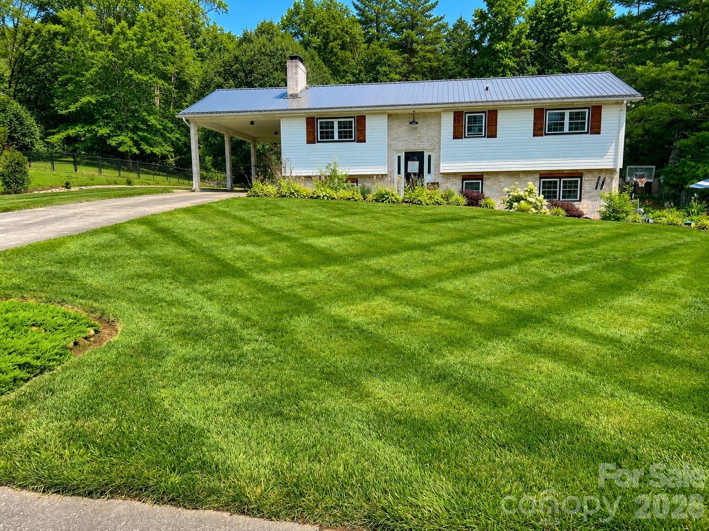 Country Comfort Awaits! If you've been searching for space, flexibility, and charm, this beautifully updated home in the desirable Virginia Acres subdivision of Hudson is ready to welcome you home. Featuring 4 spacious bedrooms, 3 full bathrooms, and two separate living areas, there's plenty of room for everyone to spread out, entertain, or accommodate multi-generational living. Step outside and unwind beneath the stunning timber-frame covered rear patio, the perfect place to enjoy peaceful evenings or your morning coffee while overlooking the beautifully manicured lawn and vibrant flower beds. Inside, you'll love the warm, inviting country atmosphere found on both levels, enhanced by numerous recent renovations that blend modern updates with timeless character. Major improvements provide added peace of mind, including a new metal roof (2024), new HVAC system (2024) and new windows (2024).
Don't miss this opportunity to enjoy country-inspired living with modern conveniences in one of Hudson's most desirable neighborhoods. $379,900