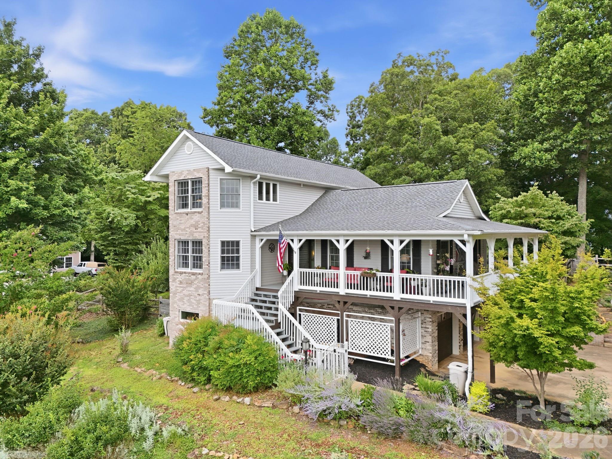 Welcome to 241 Alta Vista Drive in Candler, NC, where breathtaking year-round mountain views, thoughtful updates, and exceptional convenience come together just minutes from downtown Asheville. Offering an outstanding balance of privacy and accessibility, this beautifully maintained home showcases the best of Western North Carolina living. 

Inside, quality craftsmanship and distinctive design create an inviting atmosphere. The stunning great room showcases soaring tongue-and-groove vaulted ceilings with exposed beams, a floor-to-ceiling stone fireplace with a live-edge mantel, and expansive windows that frame the surrounding mountain landscape while filling the space with natural light. Warm wood finishes, an open-concept layout, and seamless flow create an inviting atmosphere ideal for everyday living and entertaining. The kitchen features timeless soapstone countertops, while the living spaces are highlighted by a stunning double-sided gas fireplace with a custom live-edge mantel, adding warmth and character throughout the home. A custom built-in wall unit provides both style and functionality, and a dedicated wine room offers an elegant space for storing and displaying your collection.

The large, fenced backyard offers ample outdoor space for recreation, gardening, or simply enjoying the peaceful mountain setting. The established landscape includes apple trees, cherry tree, a blackberry arbor, a rose arbor, two mature Japanese maple trees, crape myrtles, and an abundance of seasonal flowers that provide beauty throughout the year. Four rain barrels support sustainable landscape maintenance.

Conveniently located with quick access to I-40, the property is just minutes from downtown Asheville, Mission Hospital, Asheville Regional Airport, shopping, dining, local breweries, the Blue Ridge Parkway, and Pisgah National Forest. Whether used as a primary residence or mountain retreat, this home offers a rare combination of year-round mountain views, privacy, quality updates, and convenient access to many of Western North Carolina's most desirable destinations.