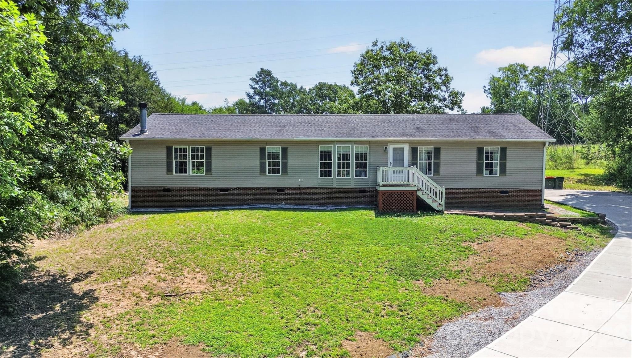 Over 1 ACRE in Ft Mill and NO HOA! Award Winning Schools! This renovated 3/2 ranch is perched up high to capitalize on the trees and privacy! Open floorplan is perfect for everyday living and entertaining with flex space to let you customize the home to how you want to live in it. Enjoy tons of natural sunlight to lift your spirits! Convenient location close to I-77, shops and restaurants.