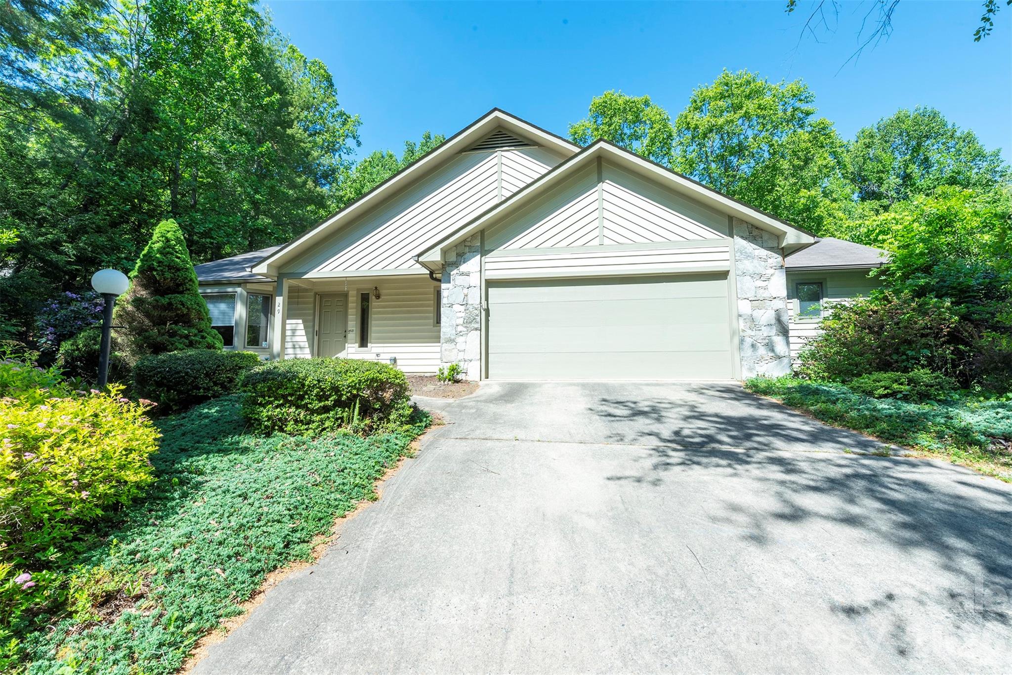 Beautifully designed one-level living in the sought after Village of Country Creek neighborhood in North Asheville, this spacious 3-bedroom, 2.5-bath home offers approximately 2,300 square feet of comfort, functionality, and thoughtful details throughout. Located in a vibrant neighborhood with access to a community pool and clubhouse as well as hiking/walking trails, this home combines convenience, connection, and easy living. The open floor plan seamlessly connects the living and dining areas, creating an inviting space ideal for both everyday living and entertaining. Skylights throughout the home fill the interior with abundant natural light, enhancing the bright and welcoming atmosphere. The well-appointed kitchen features a breakfast nook, gas range, wall oven, dishwasher, and ample workspace for cooking and gathering. The expansive primary suite serves as a private retreat with a cozy gas fireplace, oversized dual walk-in closets, soaking tub, dual vanities, and a separate shower. A versatile third bedroom easily functions as a home office, complete with built-in bookshelves and dual pocket doors for added flexibility and privacy. Additional highlights include a two-car garage, backup generator, and generous storage throughout. Step outside to enjoy the expansive deck with a retractable cover overlooking the large, private backyard—an ideal setting for relaxing, entertaining, or taking in Asheville’s beautiful seasons.